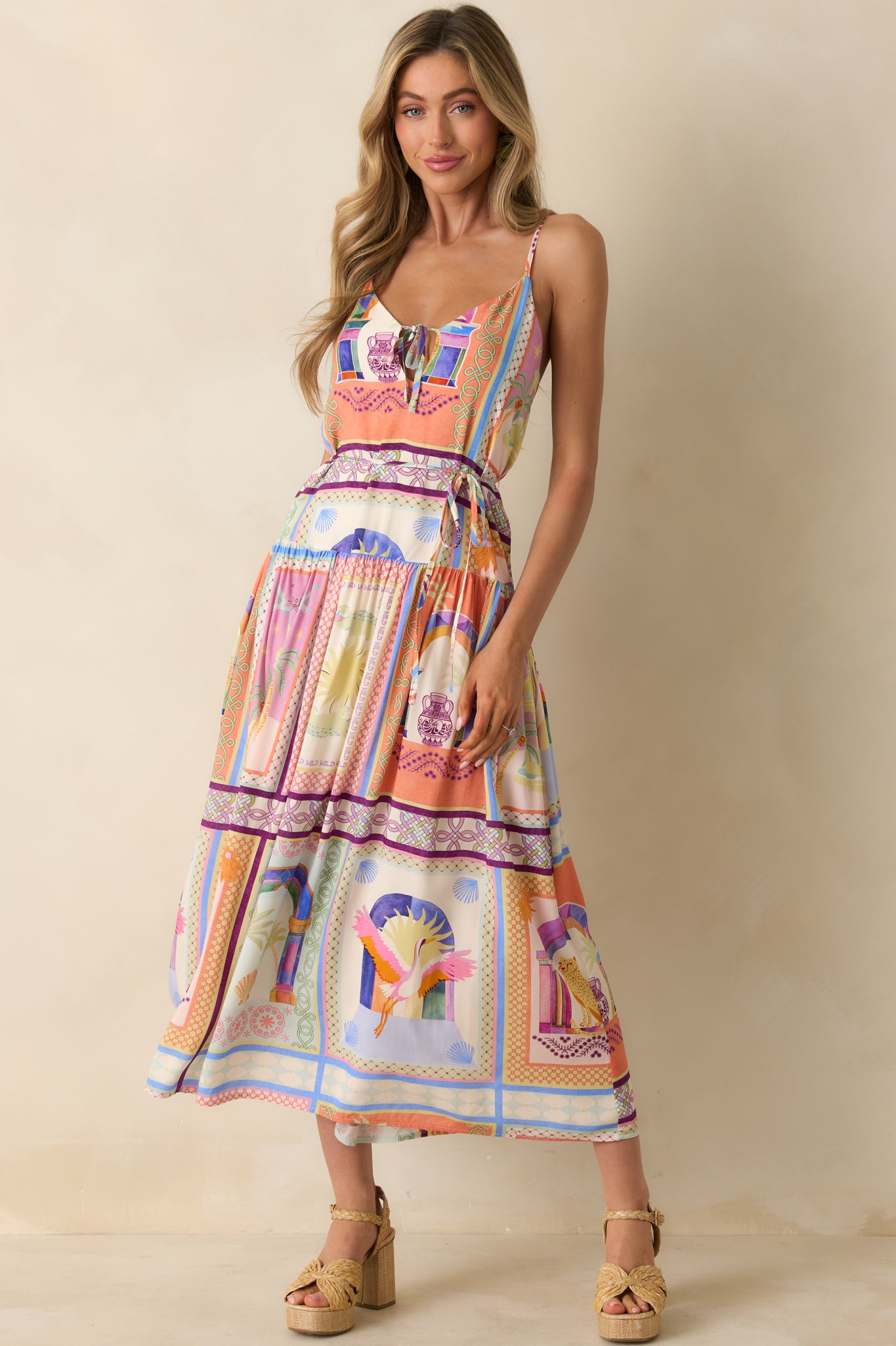 Multi-colored maxi dress featuring the V-neckline, front tie detail, and relaxed ankle-length drape.