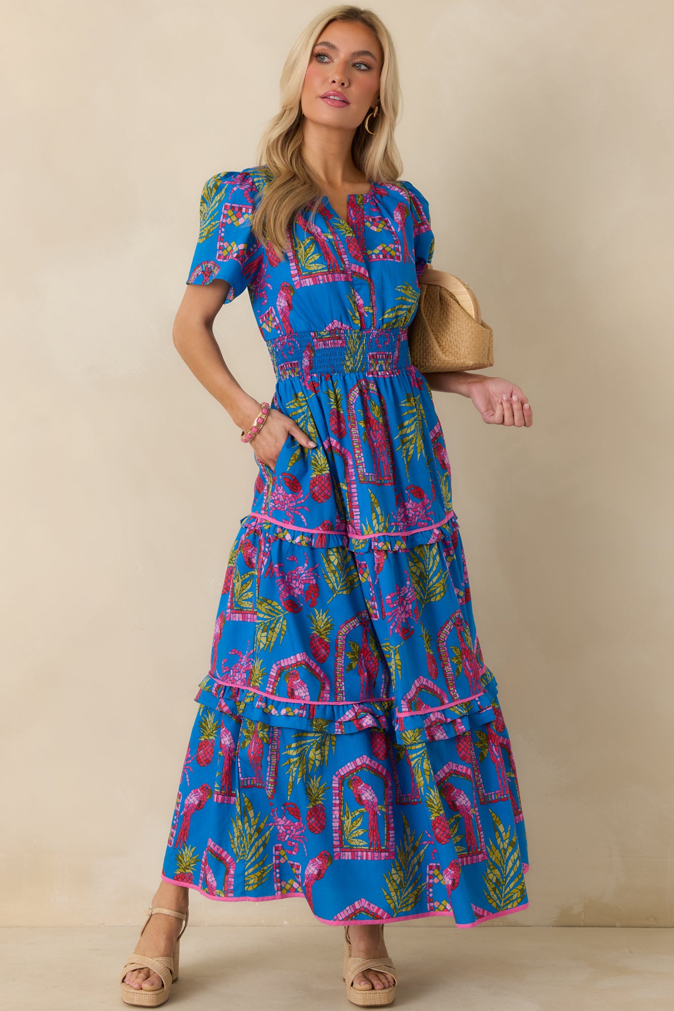 Blue multi maxi dress highlighting a split V-neckline, smocked waist, and flowing cotton fabric.