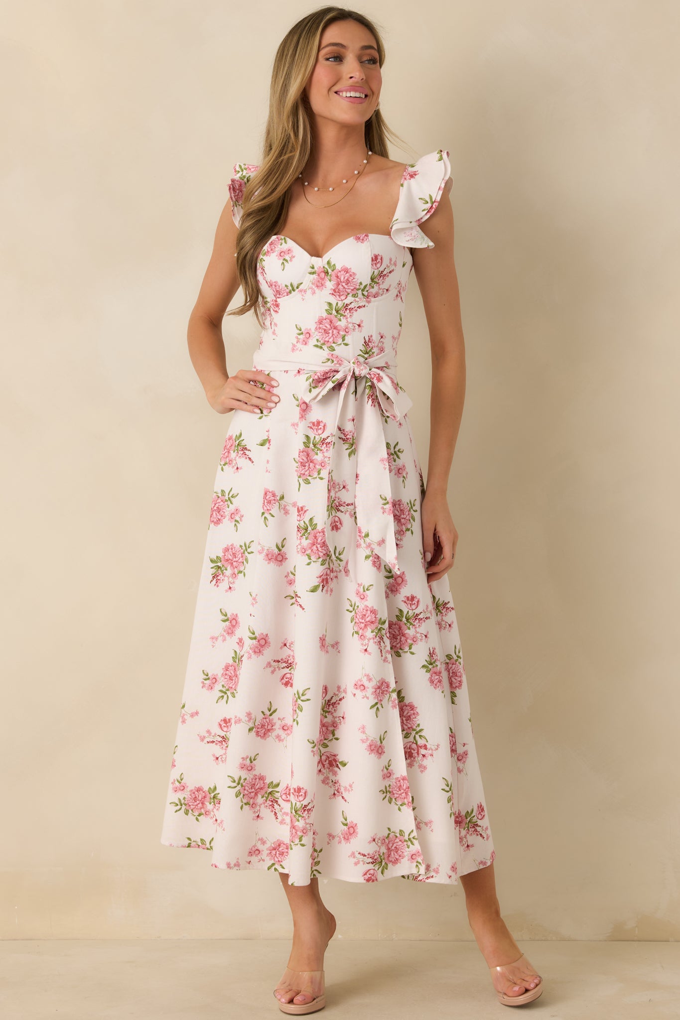 Rose floral maxi dress showcasing ruffle sleeve straps, fitted corset-inspired bodice, and a flowing skirt.