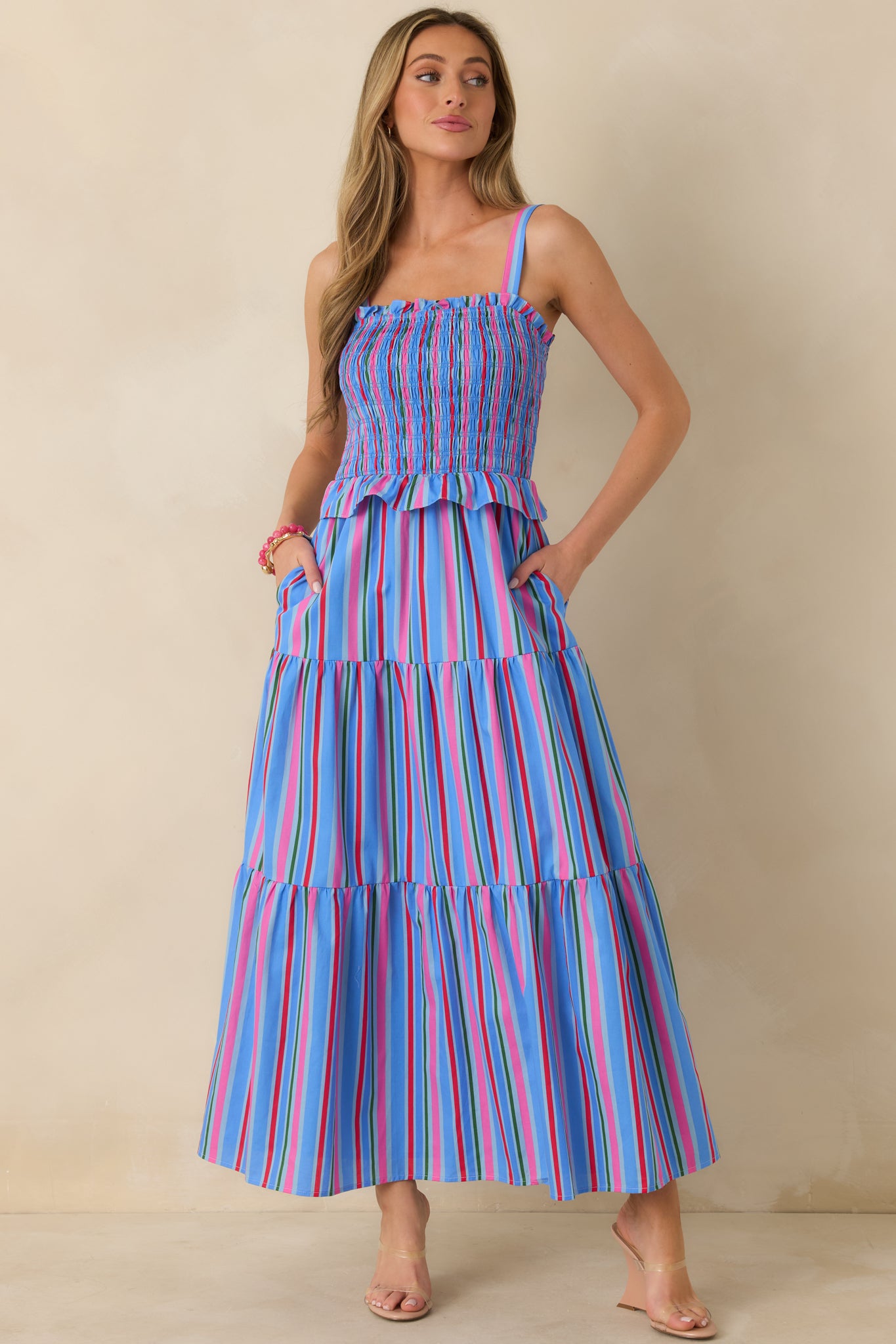 Maxi dress showcasing a square neckline, adjustable straps, and soft, flowing tiered cotton fabric.
