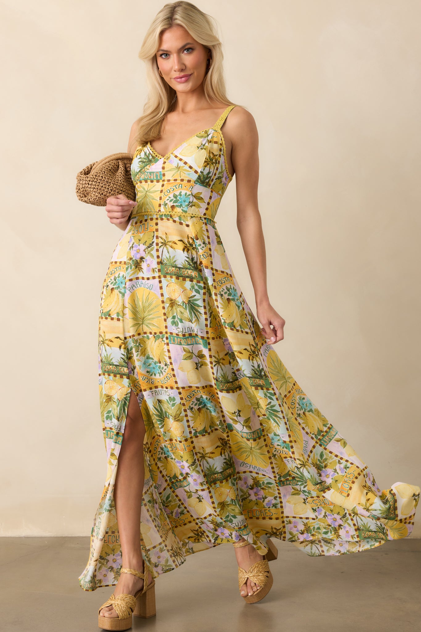 Maxi dress displayed with focus on the vibrant multicolor tropical print and tiered skirt movement.