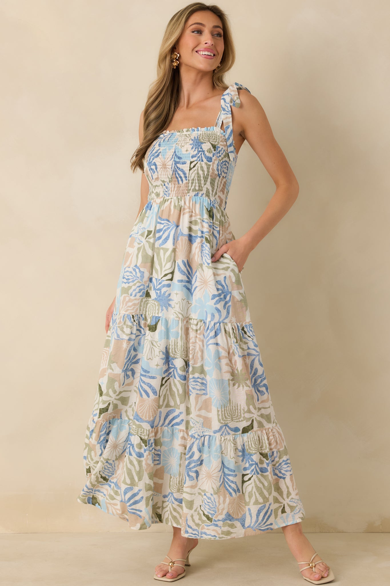 Front view of the maxi dress with a fully smocked bodice and flowy tiered skirt in lightweight woven fabric.