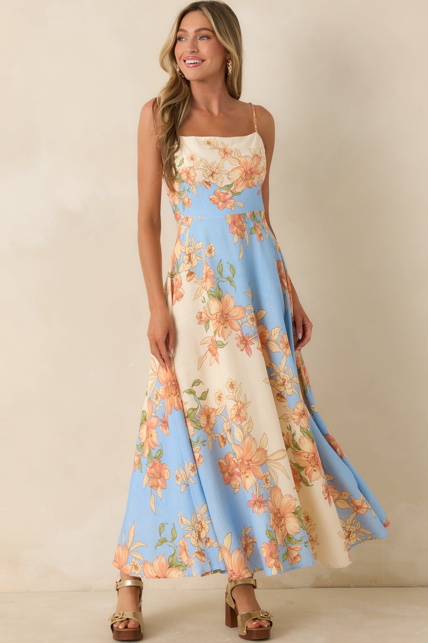 Color-block floral maxi dress with adjustable straps, a square neckline, and a flattering elongated silhouette.