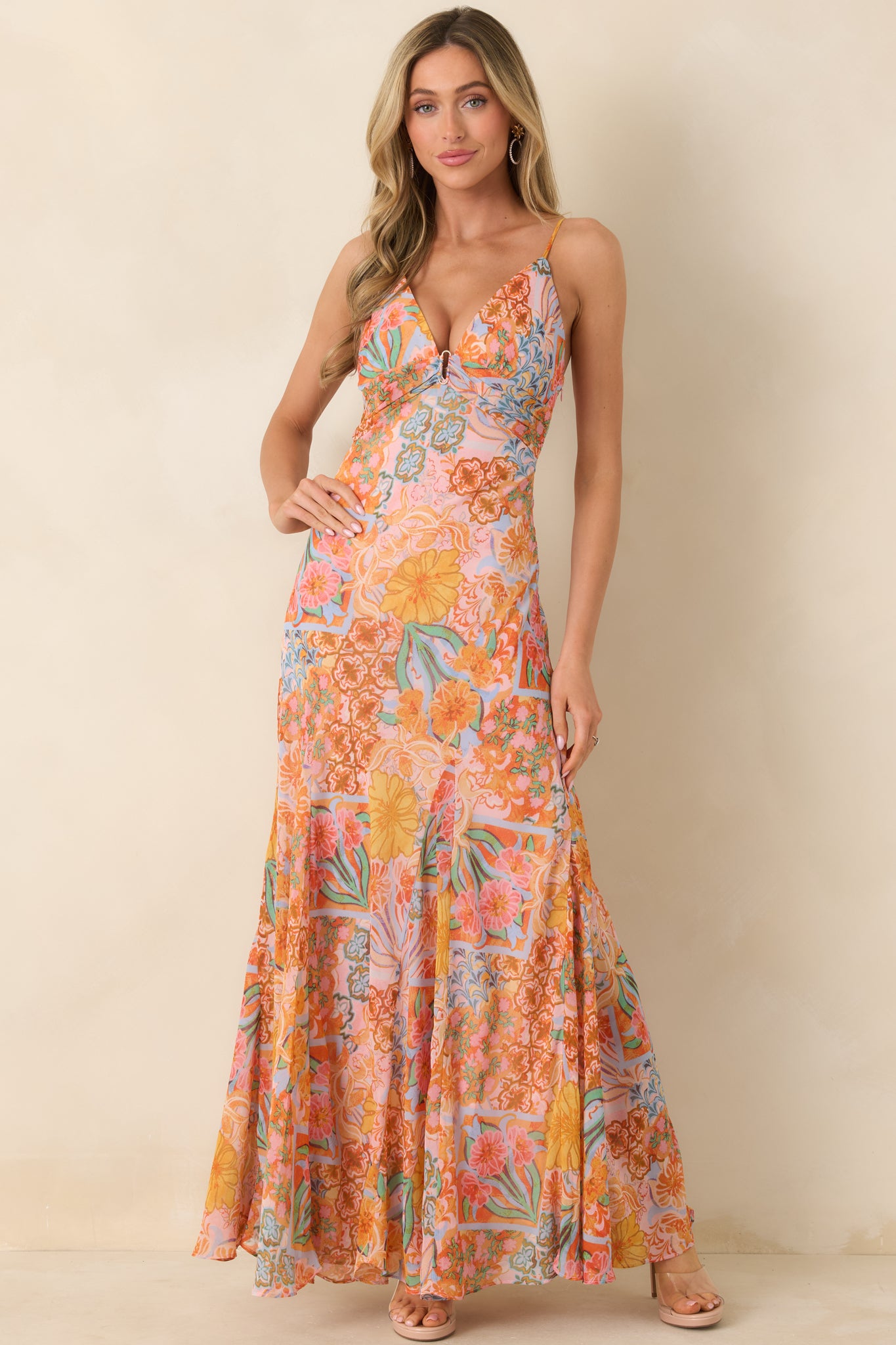 Maxi dress with soft, floaty silhouette, adjustable straps, smocked waist, and a full-length skirt showcasing a radiant pink floral design.