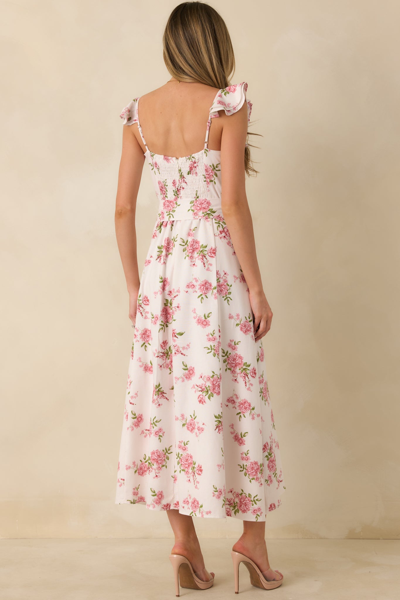 Rose pink floral maxi dress with a smocked rear panel, hidden zipper closure, and flowing full-length skirt.