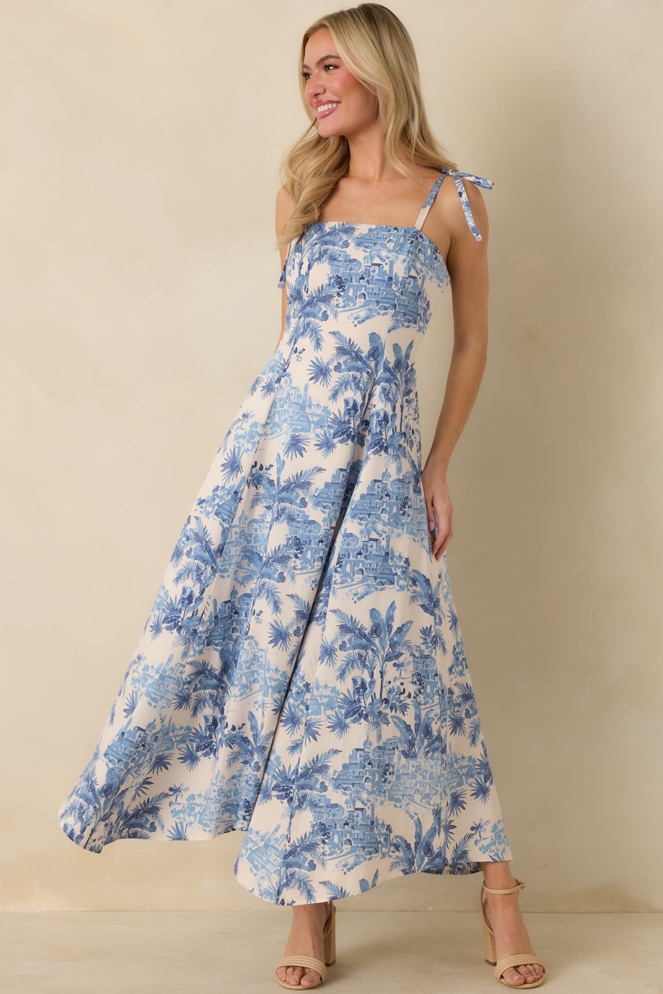 Maxi dress in blue and ivory with sweeping silhouette and wavy hemline.