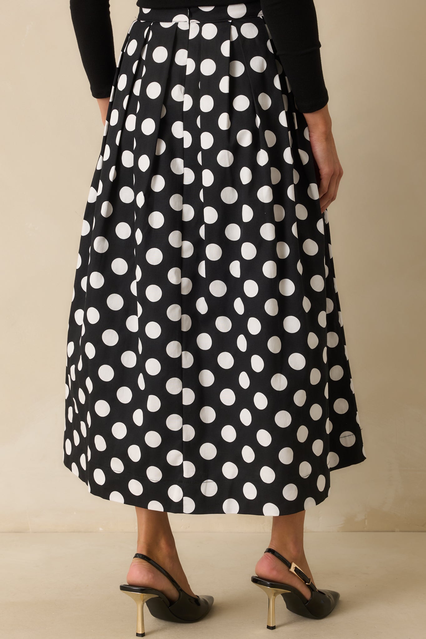 Rear view of the maxi skirt showing the hidden back zipper and A-line pleated silhouette.