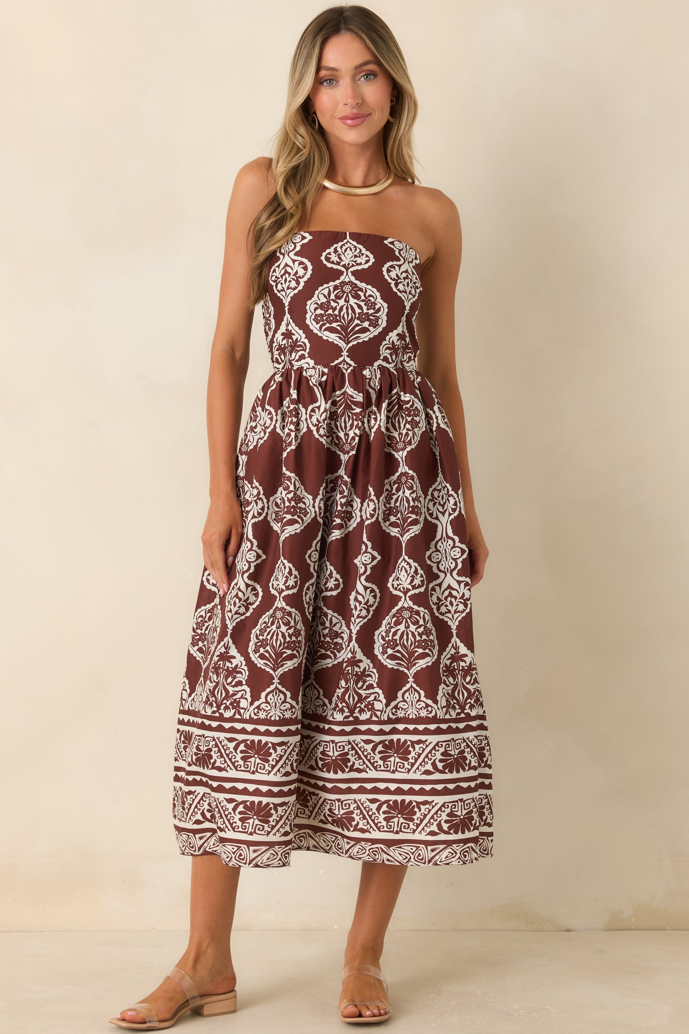 Medallion print midi dress designed with a strapless neckline, coordinating border hem, and timeless polished style.