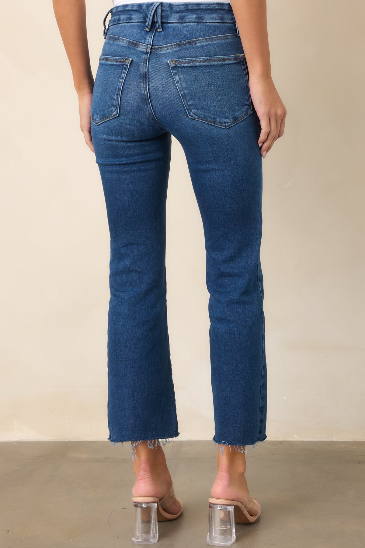 Medium indigo jeans showing the slim rear fit through the hips and subtle cropped bootcut legs.