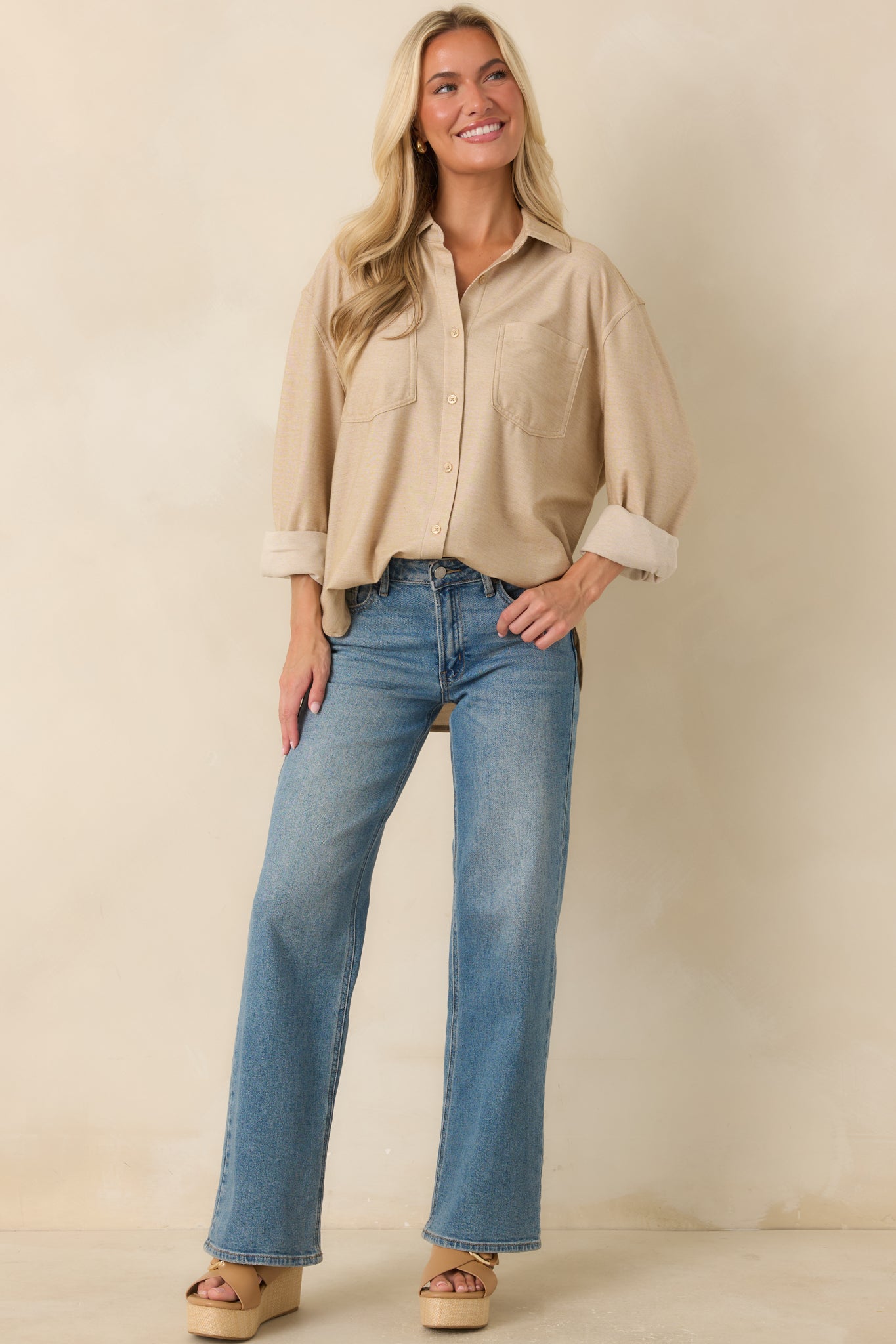 Medium wash wide leg jeans with a timeless design, complete with belt loops and a secure button closure.