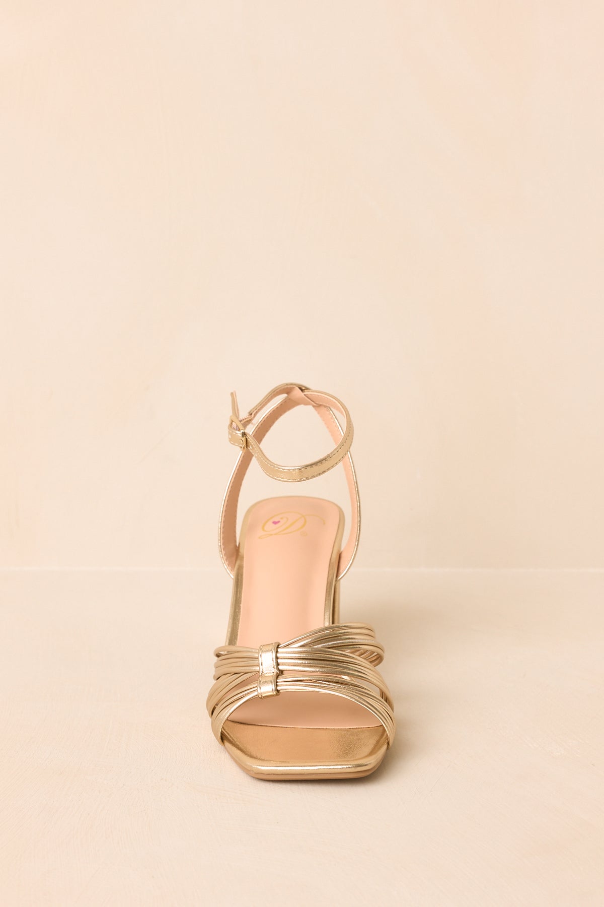 Metallic gold heels highlighting the elegant gathered toe straps, square toe shape, buckle ankle closure, and sturdy block heel.