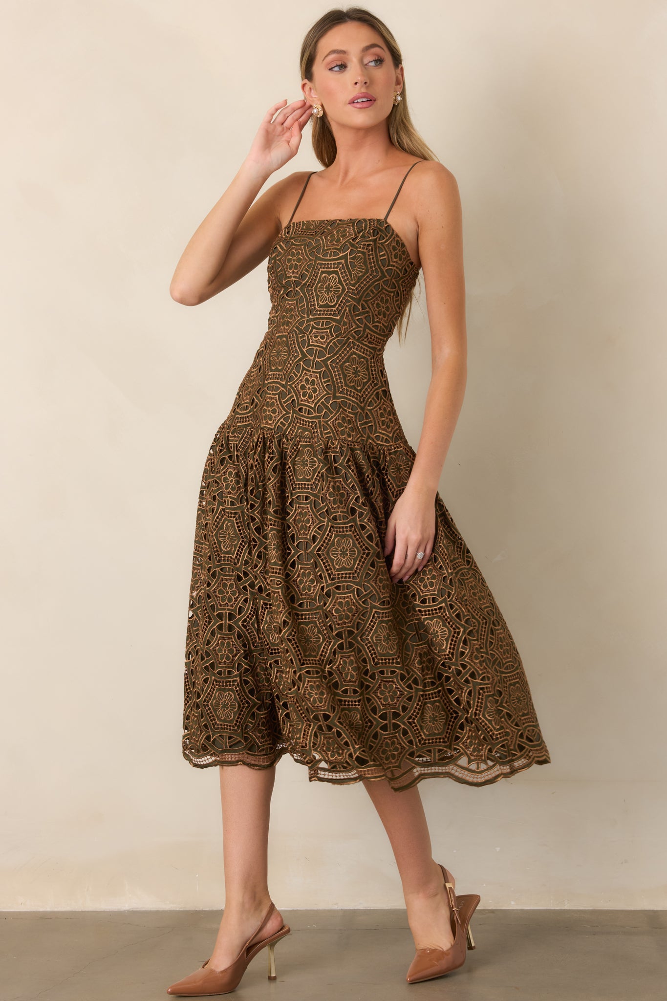 Fitted midi dress with shimmering gold lace layered over an olive lining, defined waist, and softly gathered skirt.