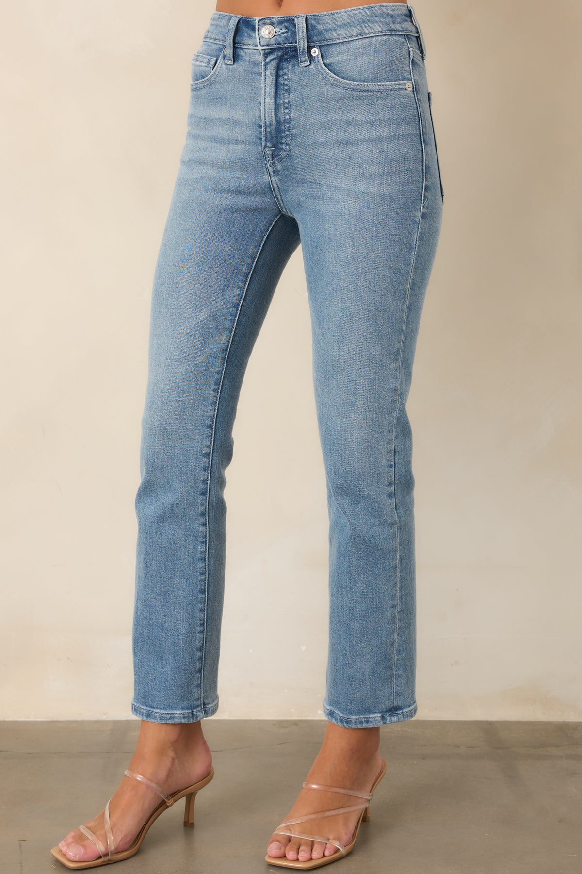 Mid-rise pants showcase the classic five-pocket construction and clean zip-fly closure.
