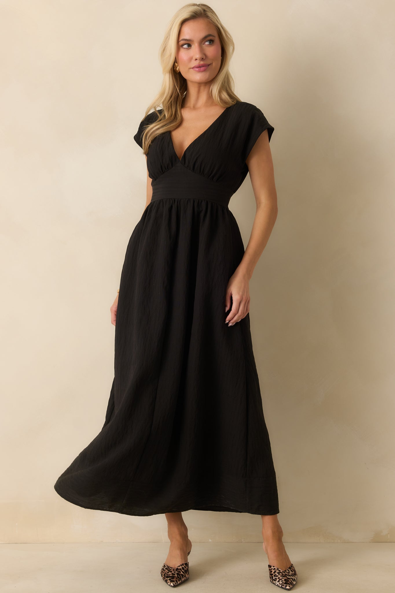 Midi dress with a back elastic waistband and subtle drape along the skirt.