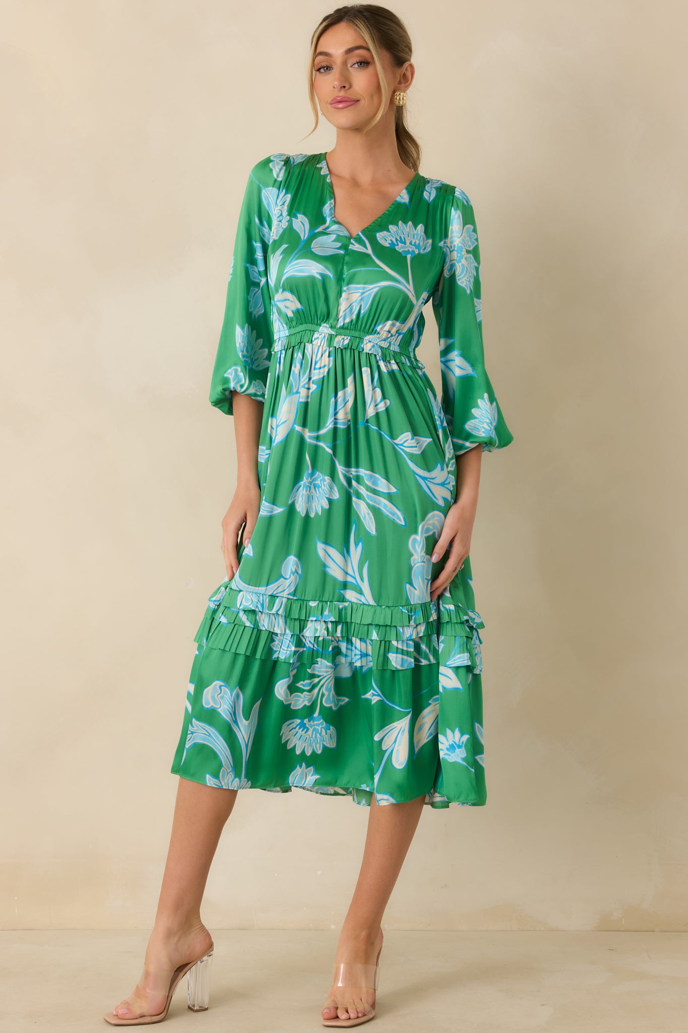 Front angle of green and blue midi dress emphasizing elastic waistband, flowing skirt, and V-neckline.