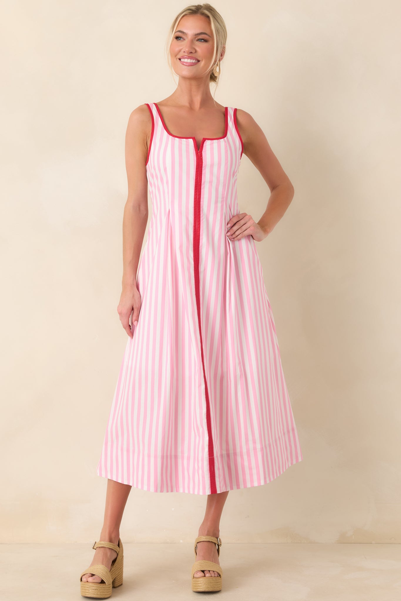 Midi dress featuring red trim accents, structured bodice, and breezy midi-length skirt.