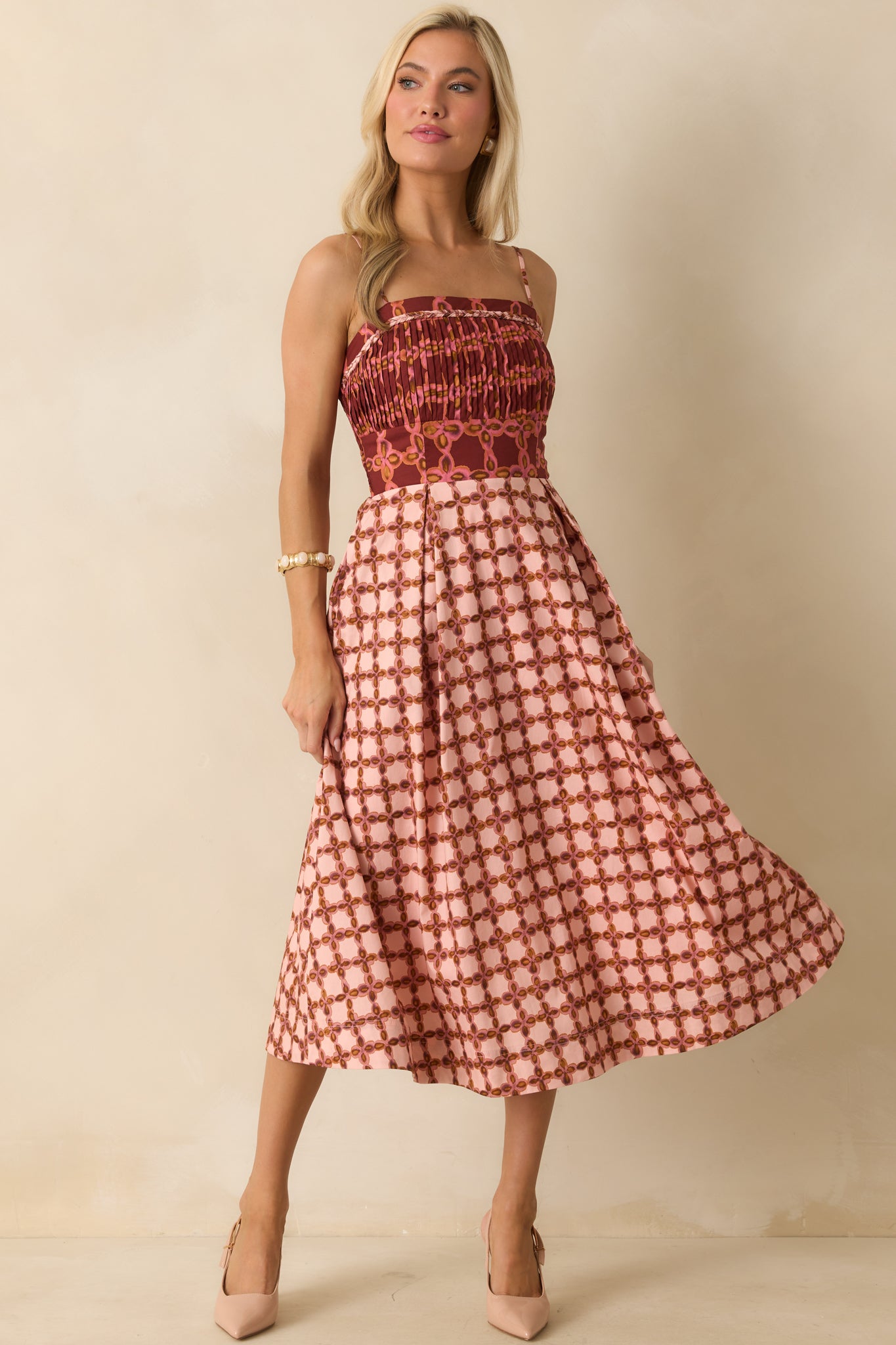 Midi dress featuring a pleated bodice, adjustable spaghetti straps, and functional pockets.
