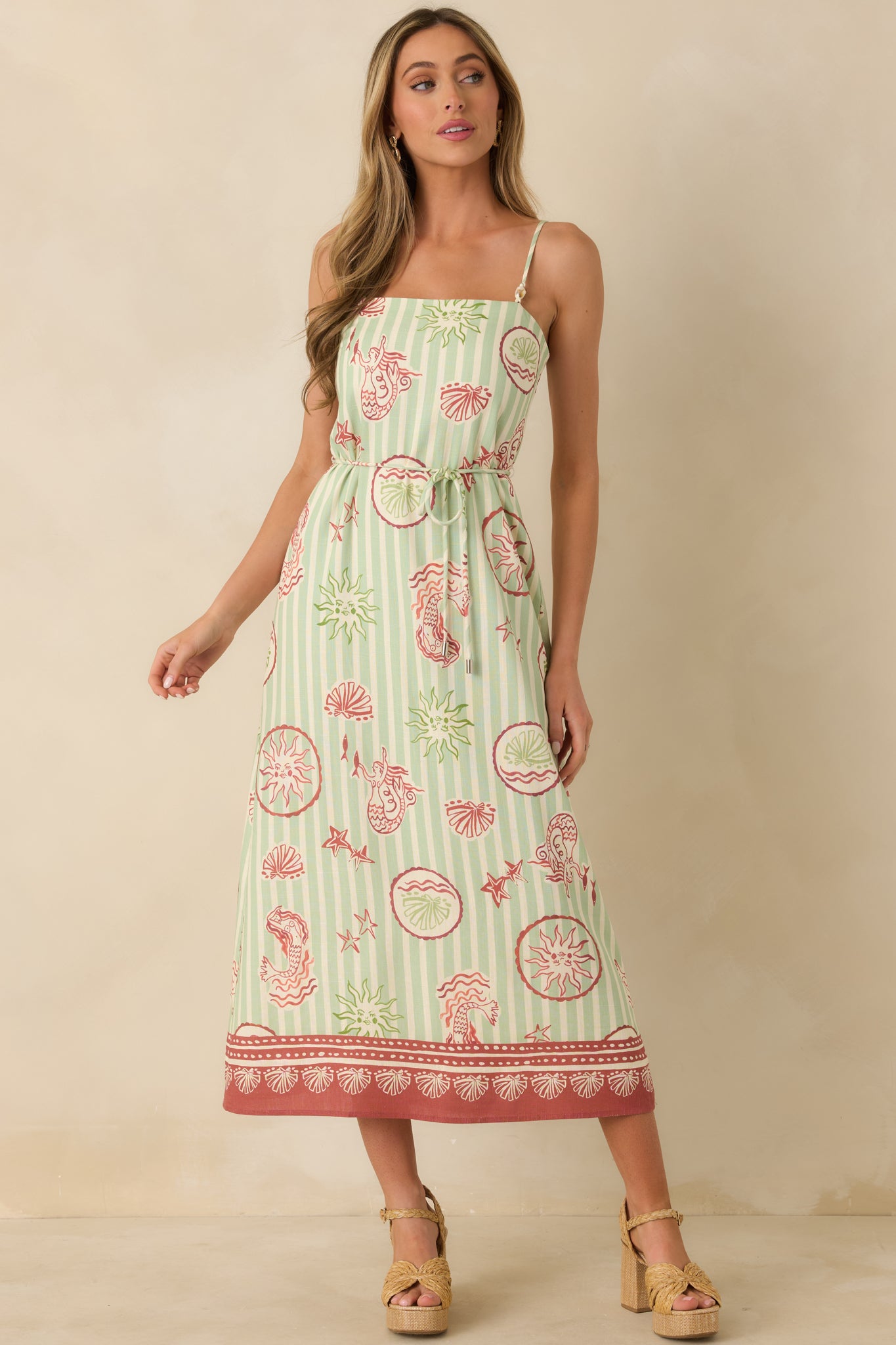 Midi dress in green stripes showcasing breathable fabric, fluid drape, and customizable front tie waist.