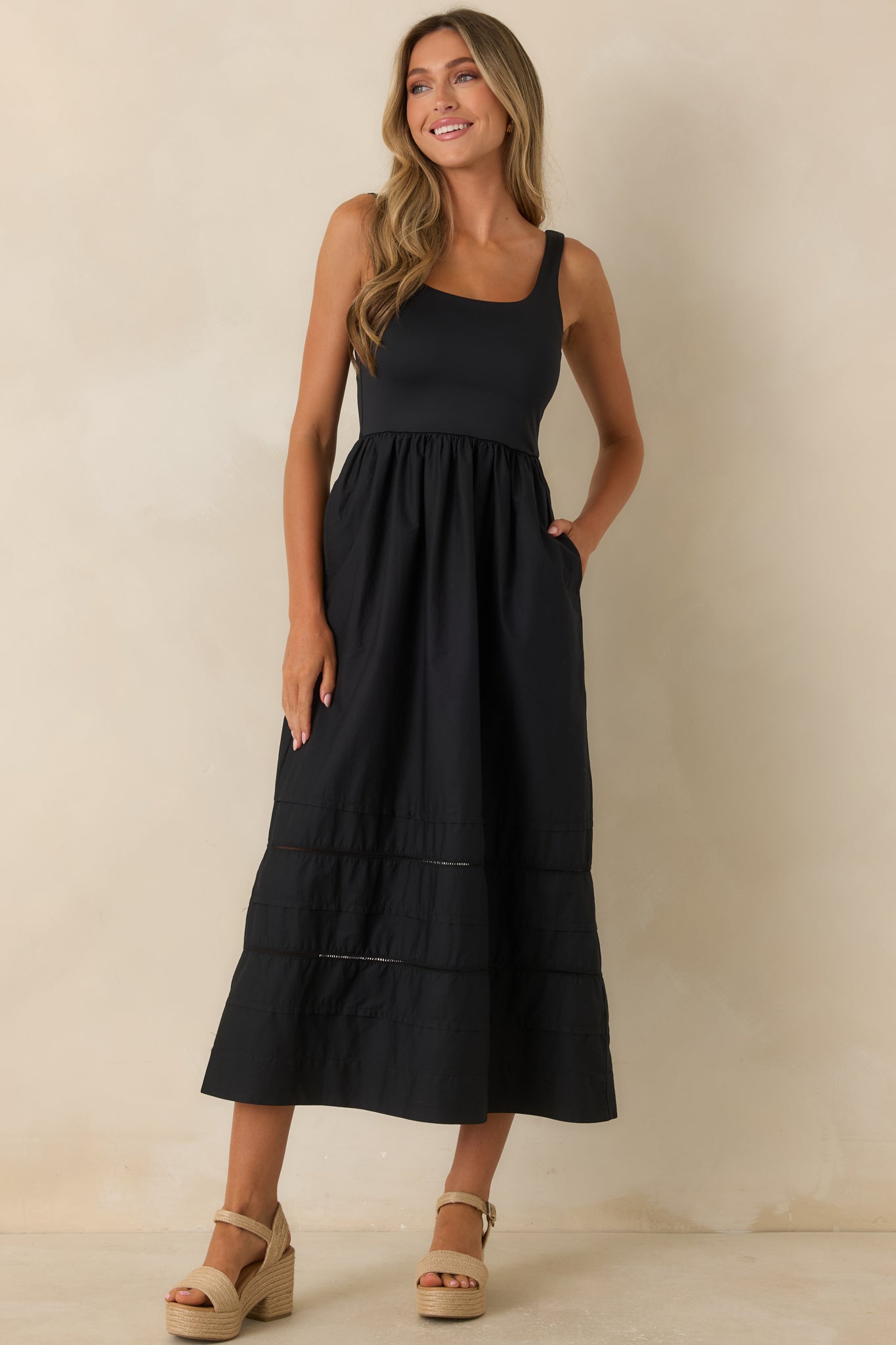 Midi dress showcasing a sleeveless silhouette, gathered skirt, and effortless movement.