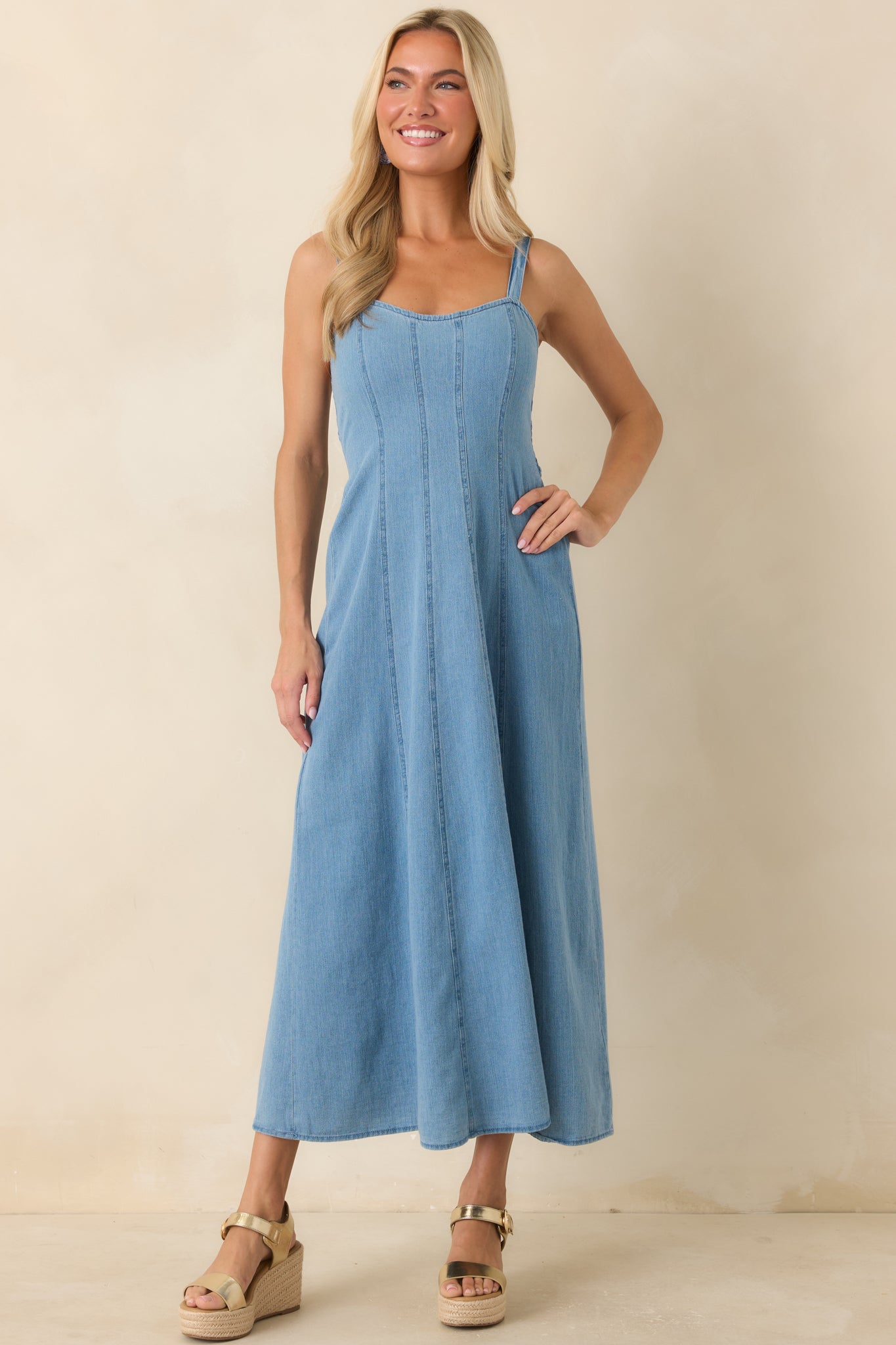 Midi dress with a square neckline, fitted bodice, and graceful movement through the skirt.