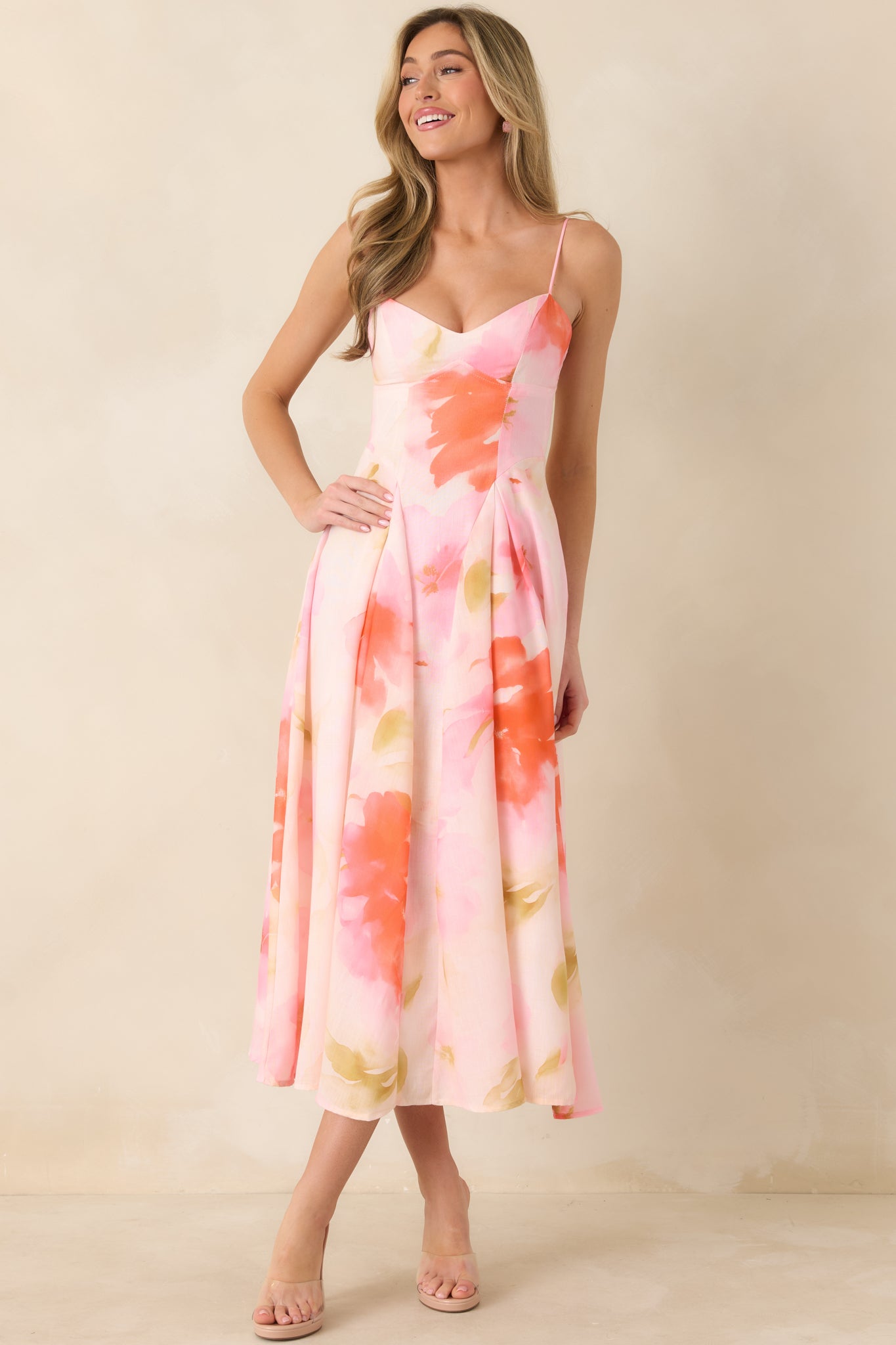 Midi dress with structured sweetheart-inspired neckline, adjustable spaghetti straps, and fitted waist.