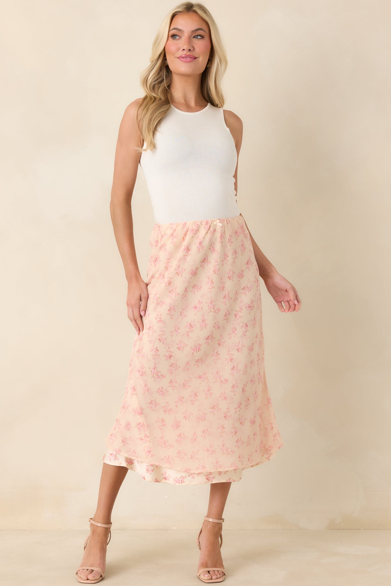 Feminine midi skirt in airy chiffon, showcasing a delicate pink floral print and a fluid silhouette that drapes effortlessly.