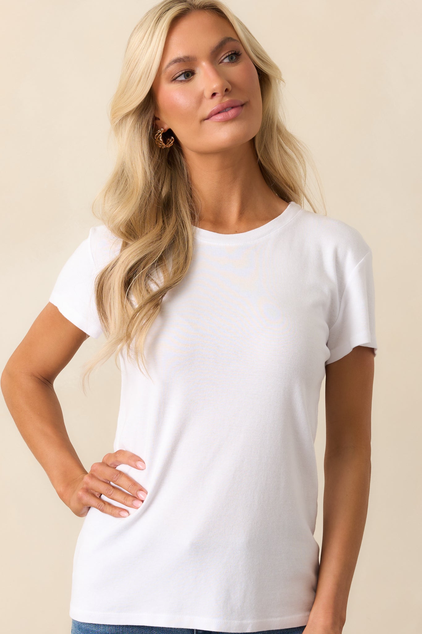 Midsection crop highlighting the tee’s relaxed fit and lightweight drape over the torso.