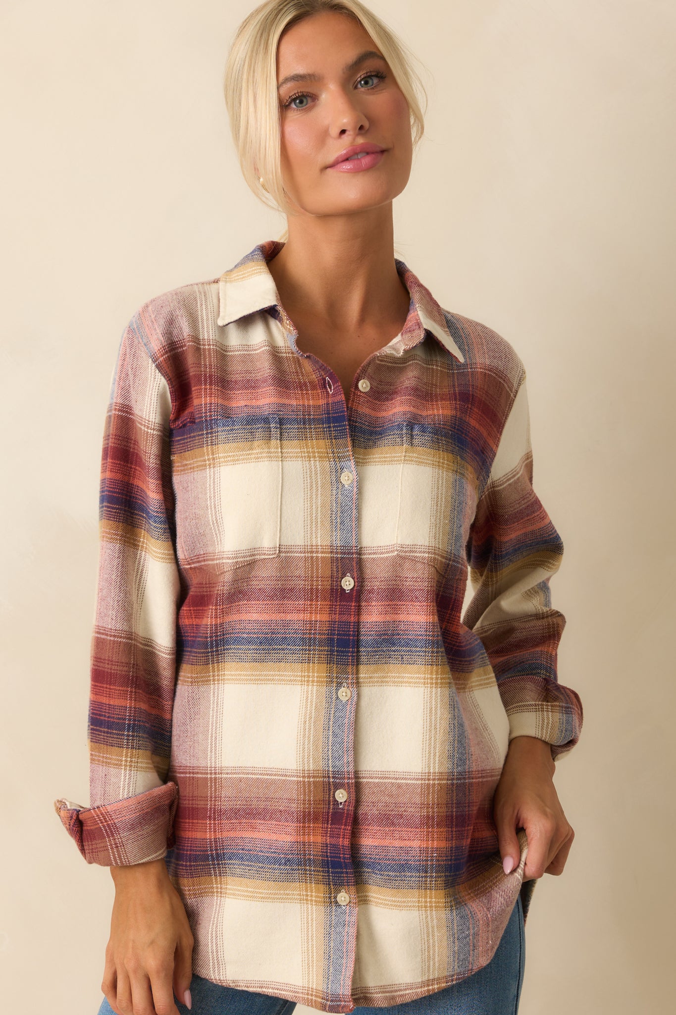 Midsection crop of ivory flannel shirt showing scoop bottom hem and plaid detailing.