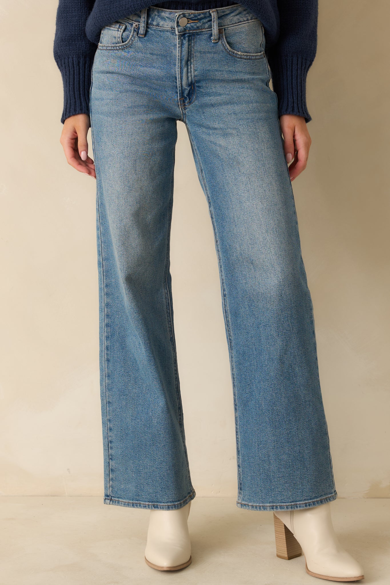 Midsection crop showing the top of the wide-leg jeans and pocket openings.