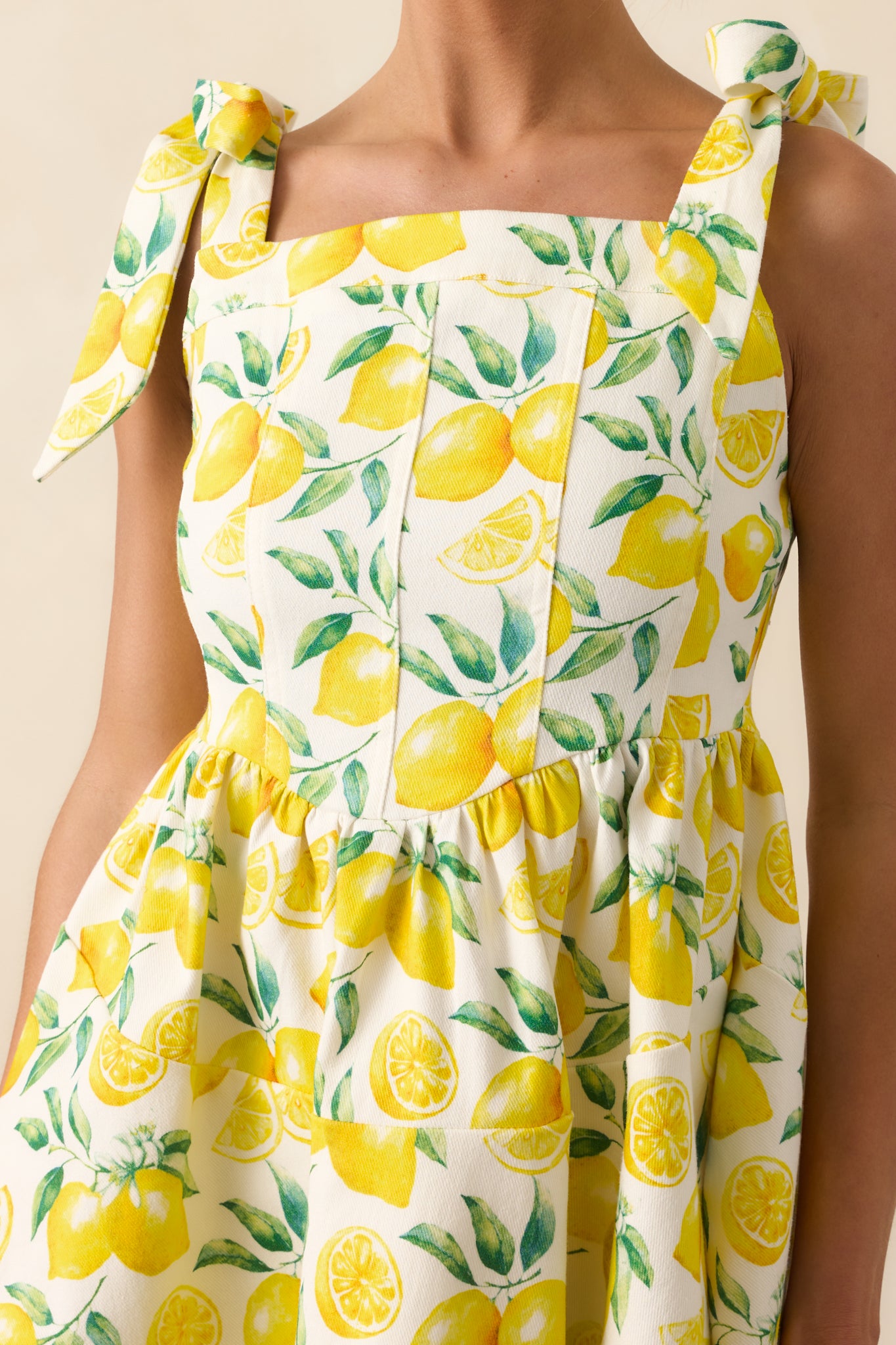 Close-up of the lemon print and seam detail, capturing the fabric texture and panel construction.