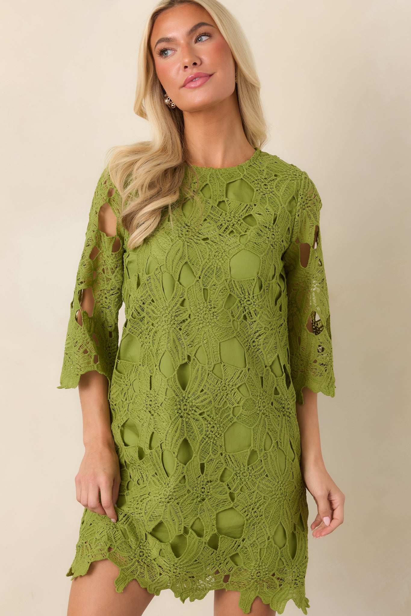 Front detail of the mini dress emphasizing the smooth opaque body, airy sleeve texture, and clean neckline finish.