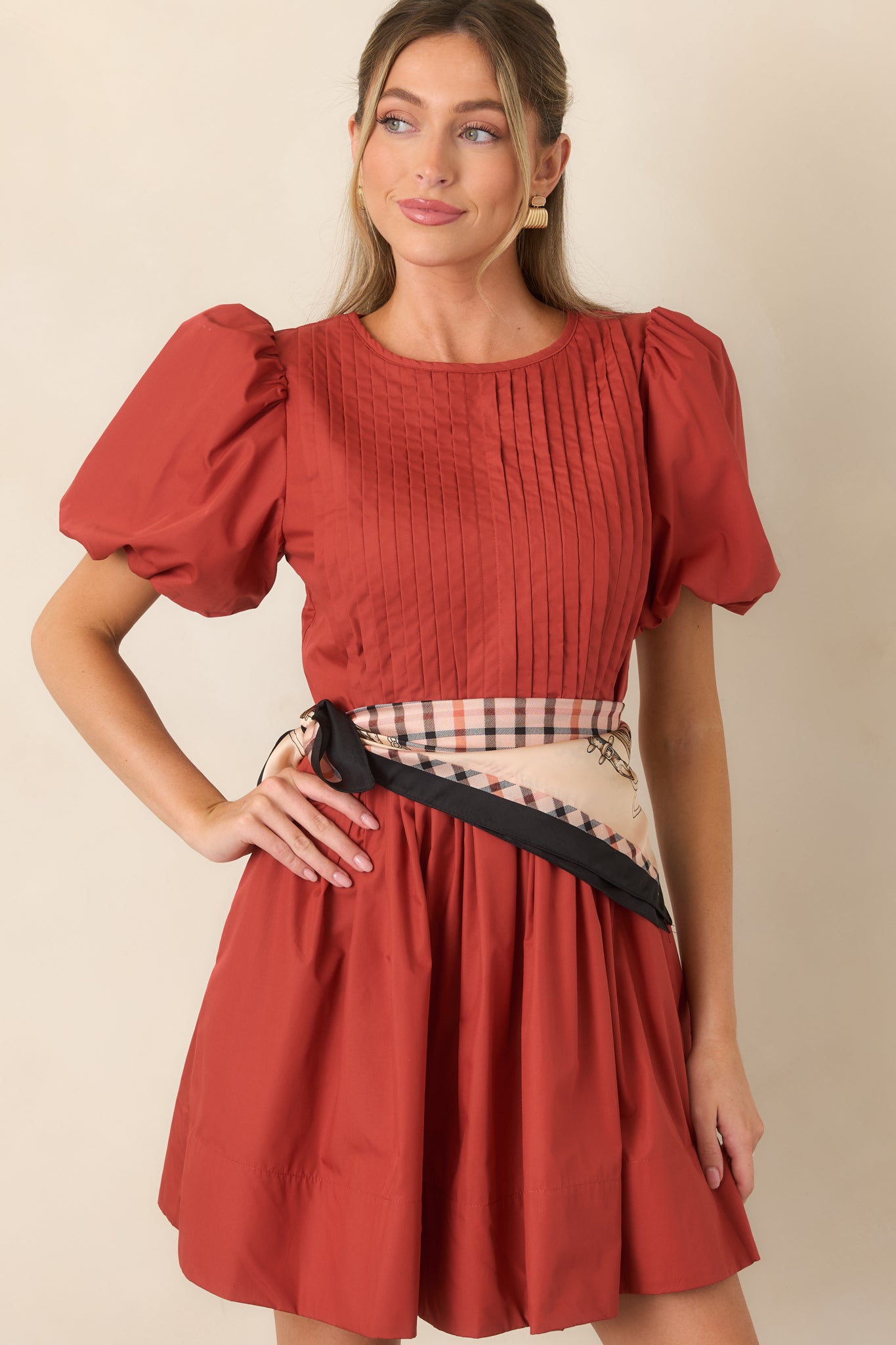 Close view of the mini dress highlighting the intricate pintucking across the bodice and softly gathered skirt.