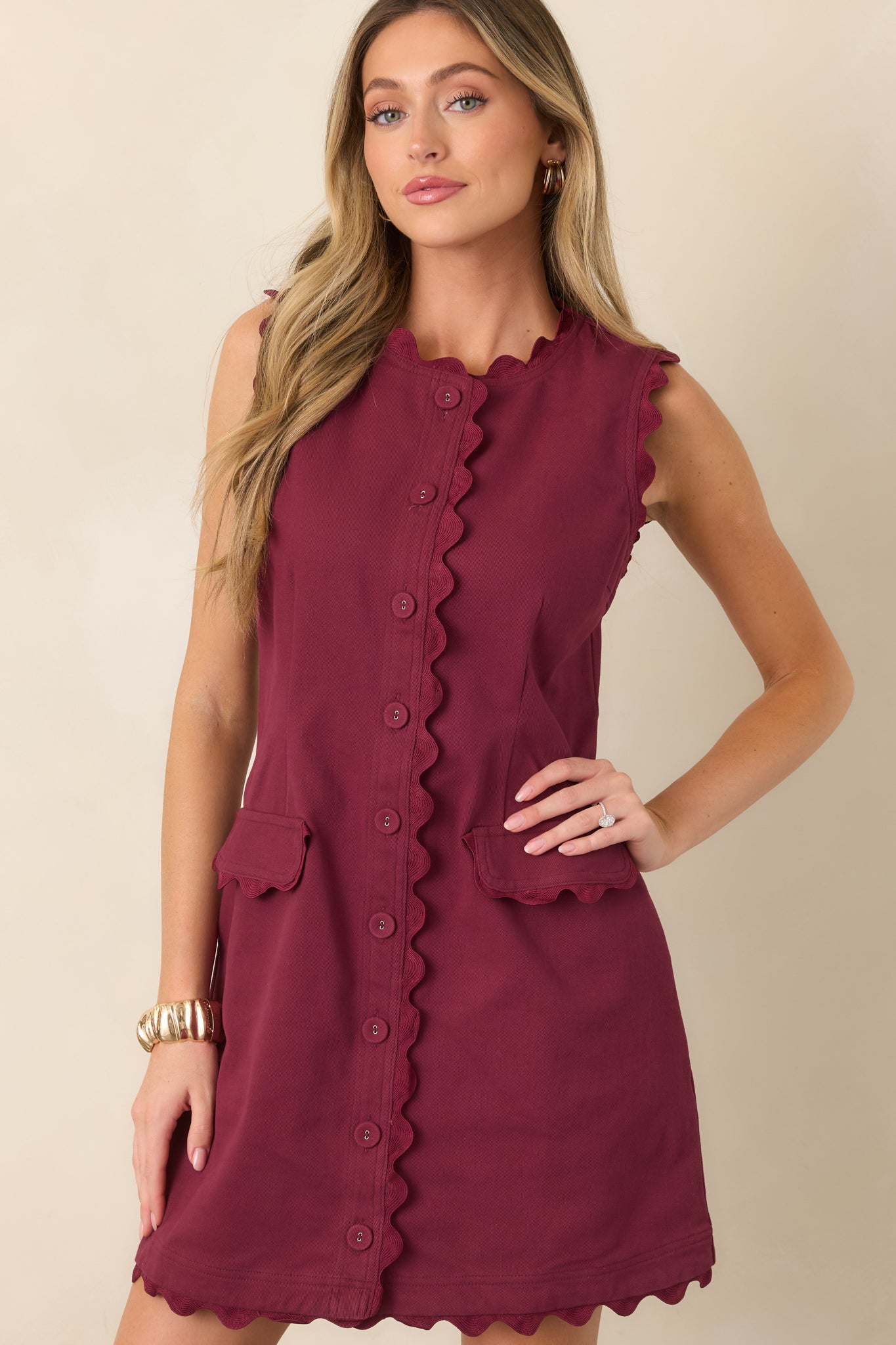 Close view of the mini dress highlighting the tonal ric rac trim around the neckline and button-front placket.