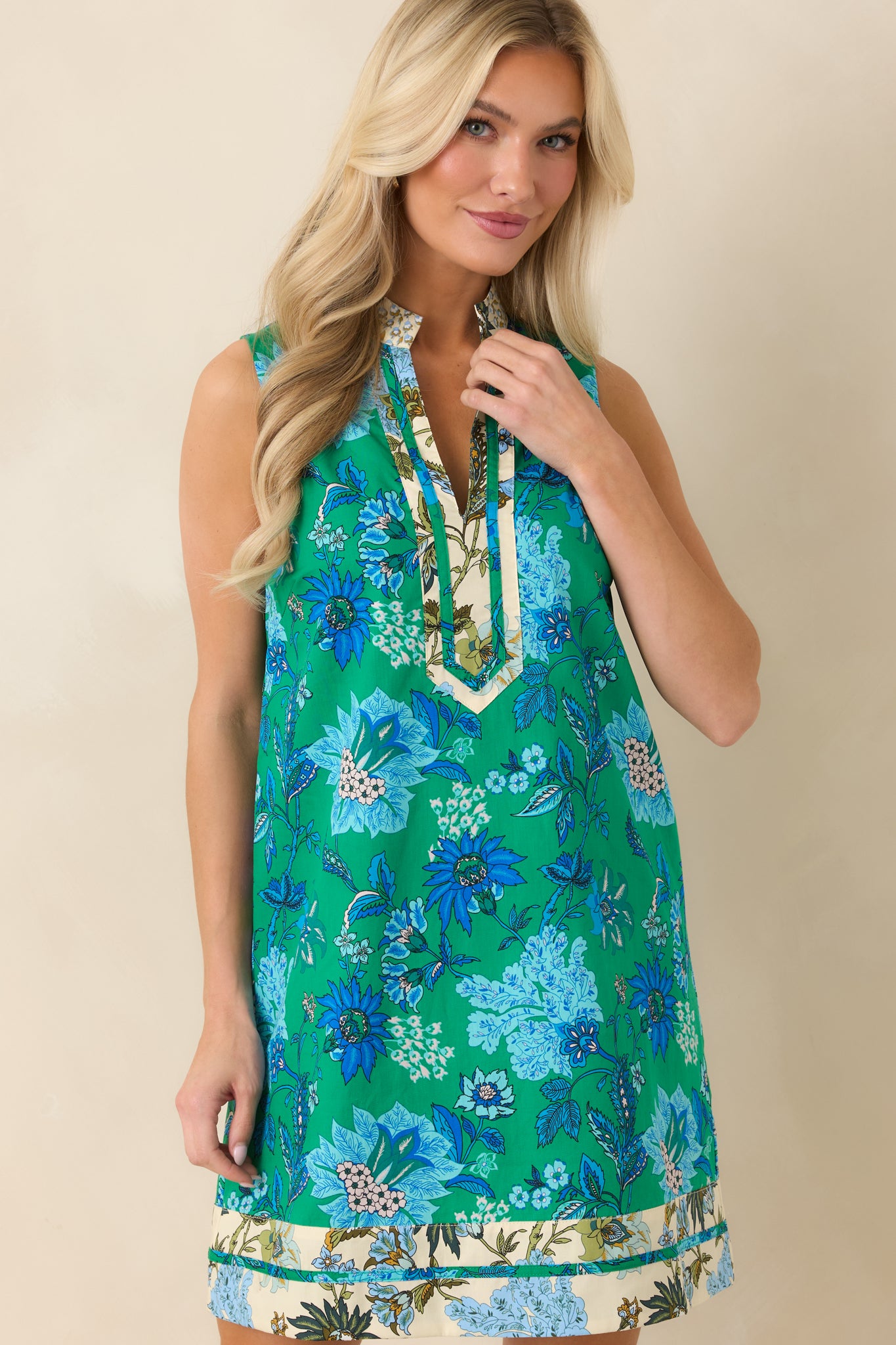 Mini dress close-up showing structured trim at neckline and hem.