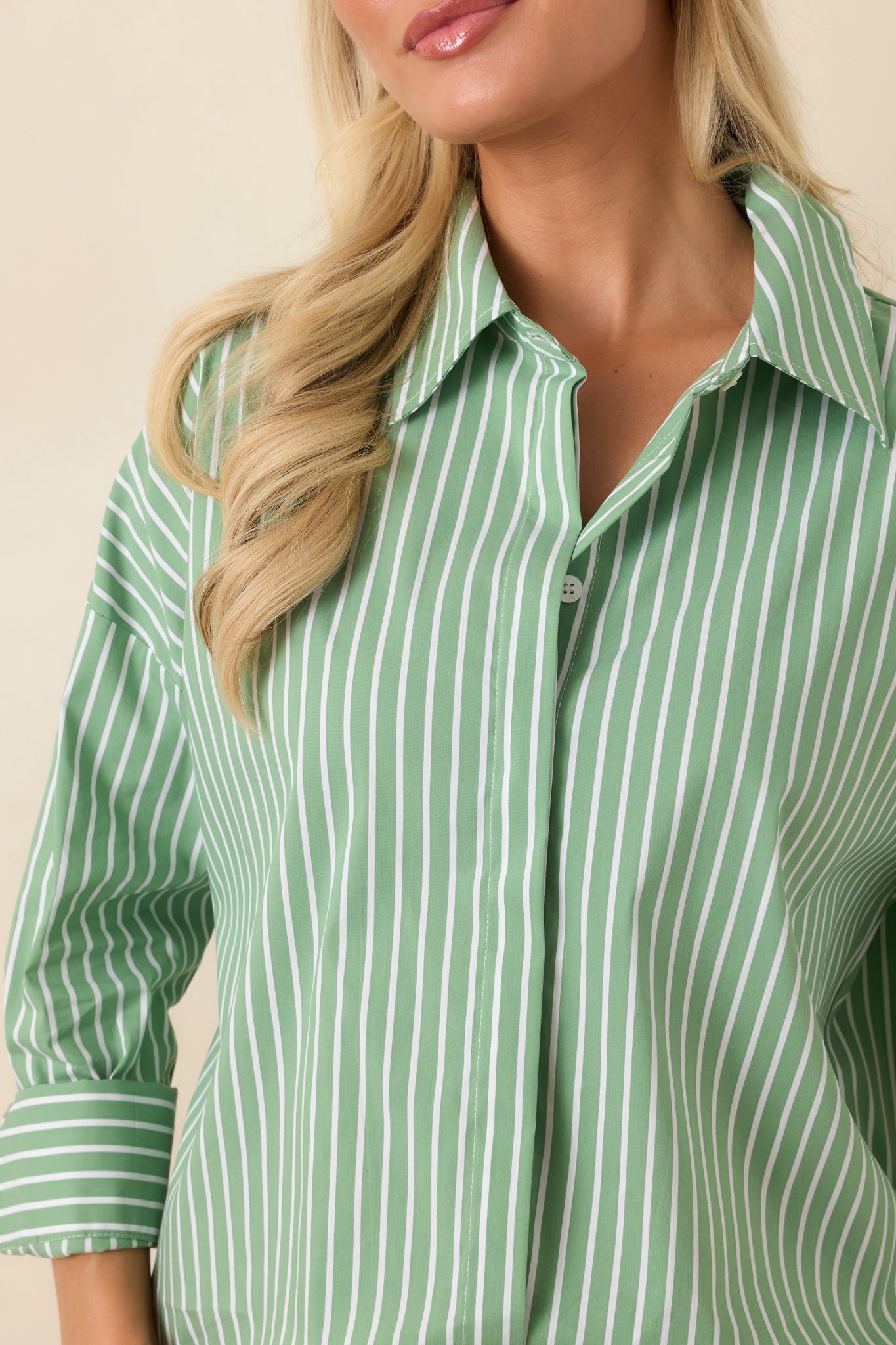 Close-up of the mint green striped shirt highlighting the crisp collar edge, button detailing, and cotton blend weave.
