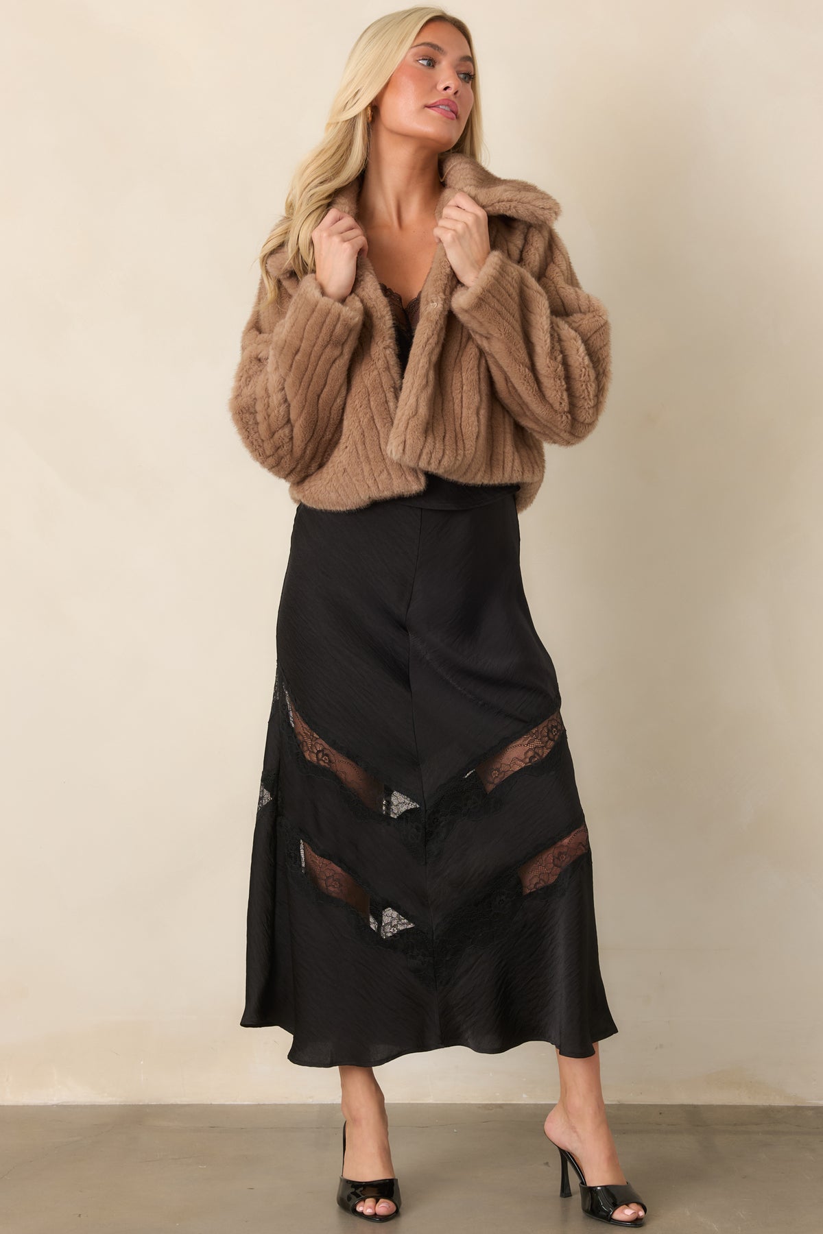 Mocha brown faux fur jacket showcasing its soft ribbed texture and relaxed cropped silhouette.