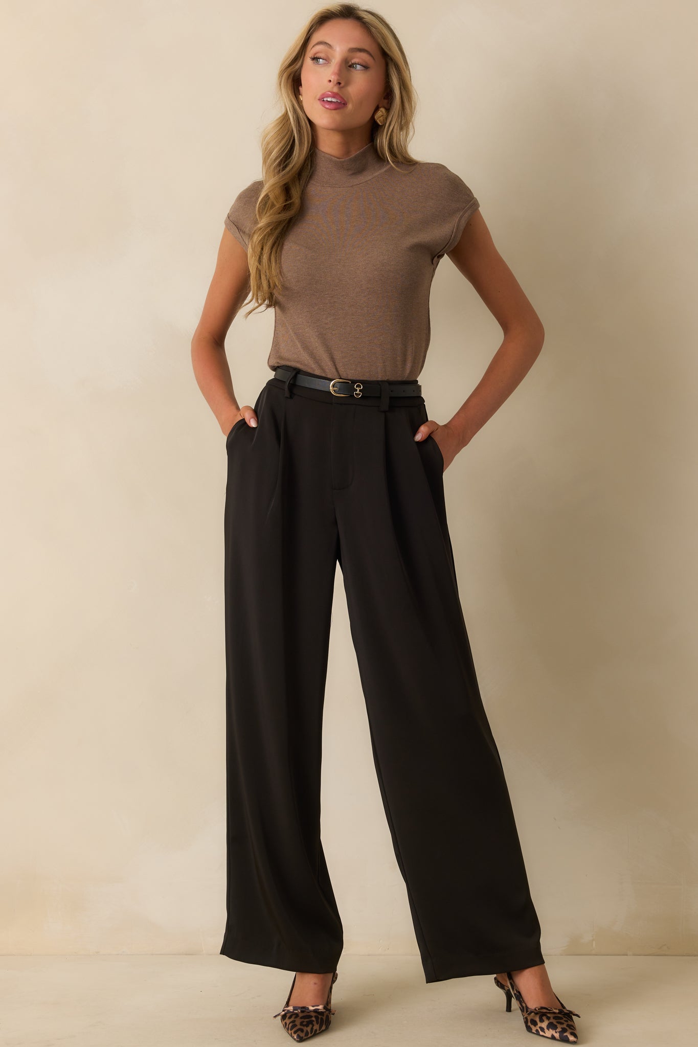 Mocha brown ribbed knit top with a mock neckline, short sleeves with rolled cuffs, and a fitted silhouette.