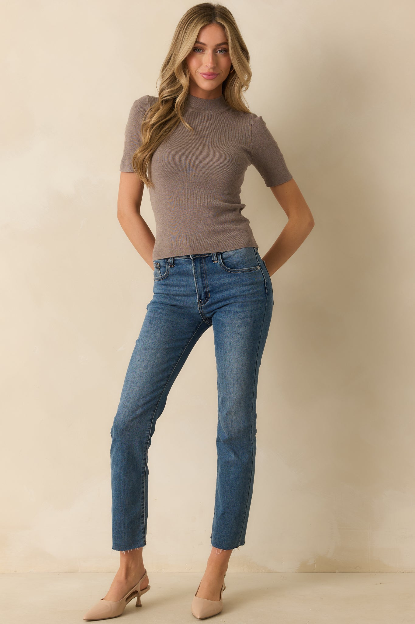Mock-neck dark taupe top with a streamlined fit and ribbed detailing throughout.