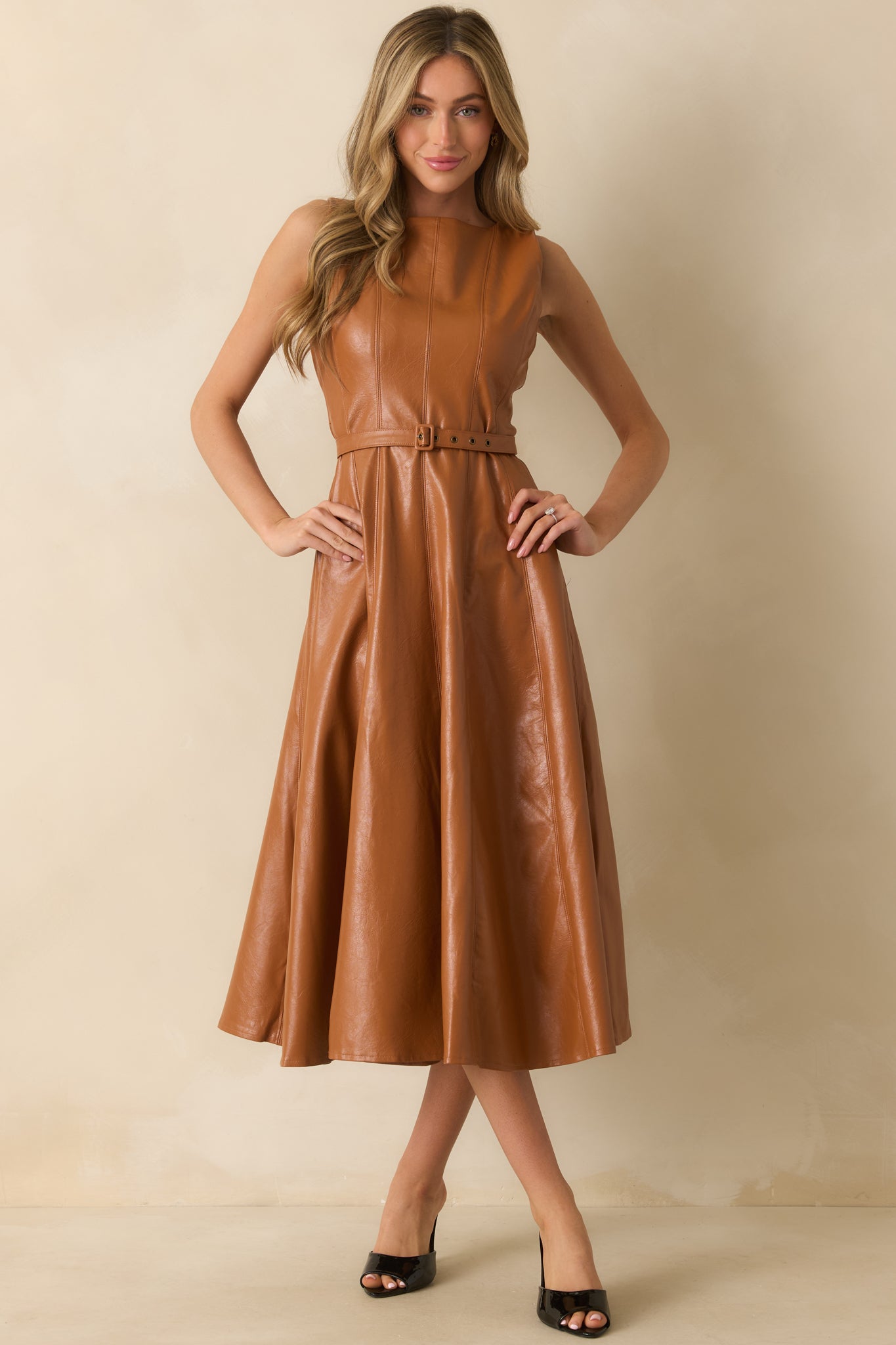 Modern faux leather midi dress in caramel tone with round neck, belted waist, and pocket detail.