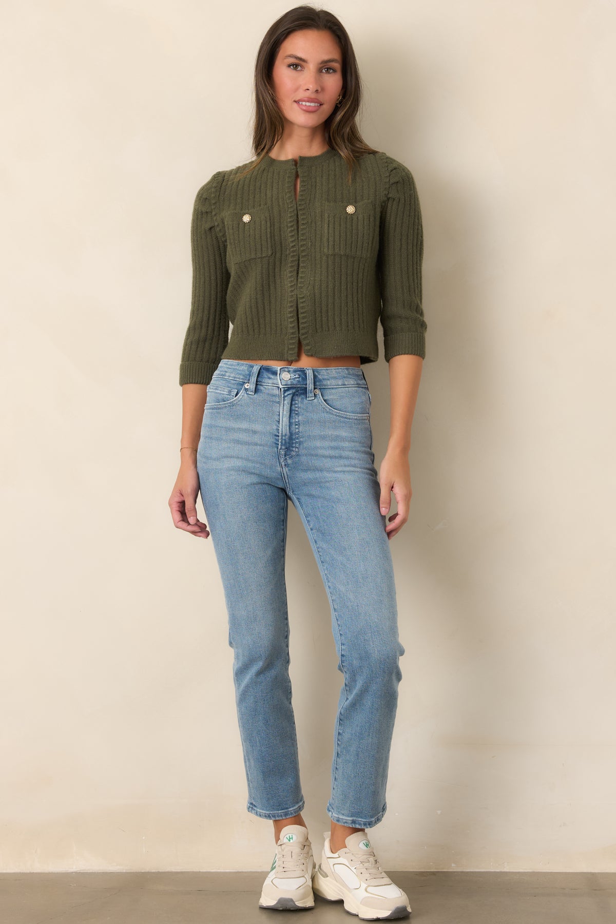 Earthy moss green cardigan featuring a round neckline, ribbed edging, and two buttoned chest pockets.