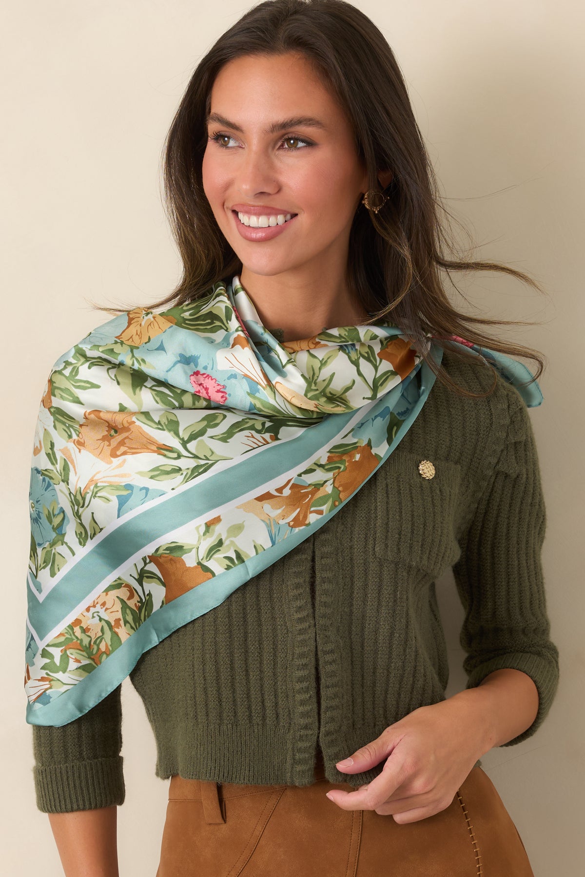 Round neckline and ribbed edging frame the front of the earthy moss green cardigan.