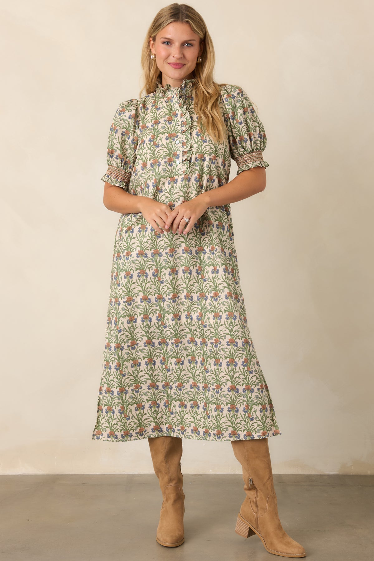 Mossy green botanical print dress with a ruffled collar, puff sleeves, and practical side pockets.