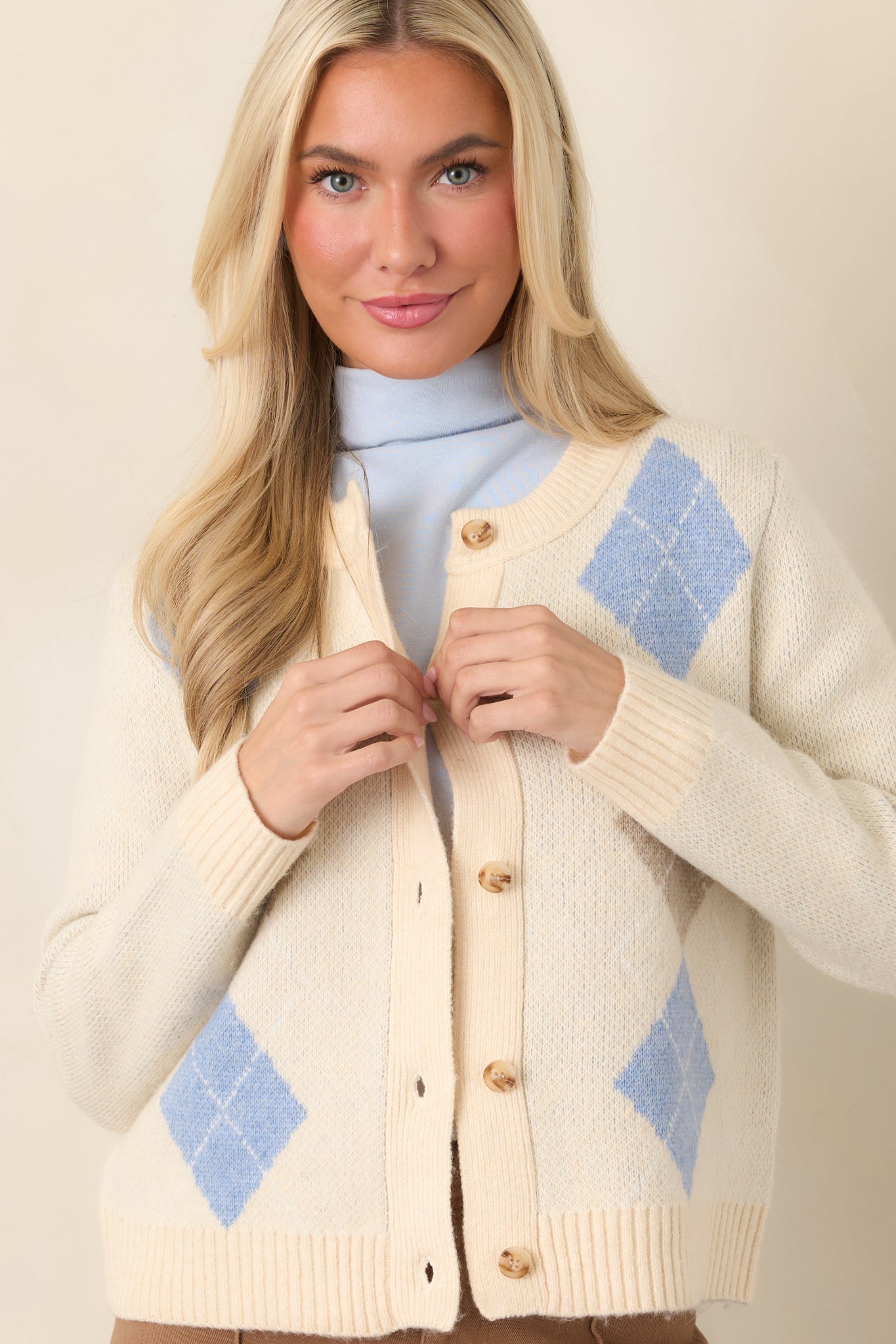 Multi knit cardigan showcasing the dimensional argyle stitching, long sleeve construction, and ribbed cuff finish.