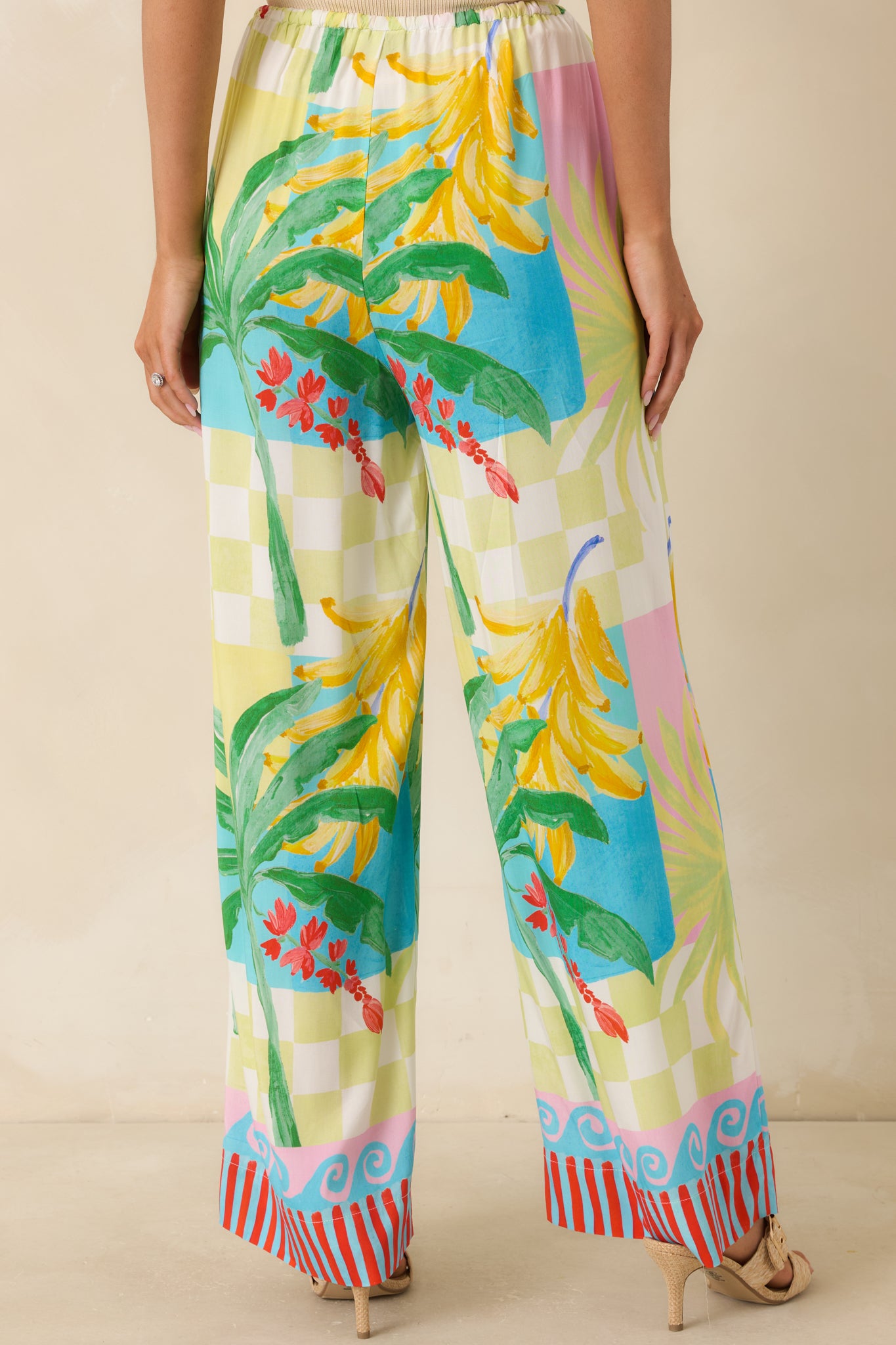 Back view of the multi-color tropical pants highlighting the relaxed wide-leg fit, elastic waistband, and flowing silhouette.
