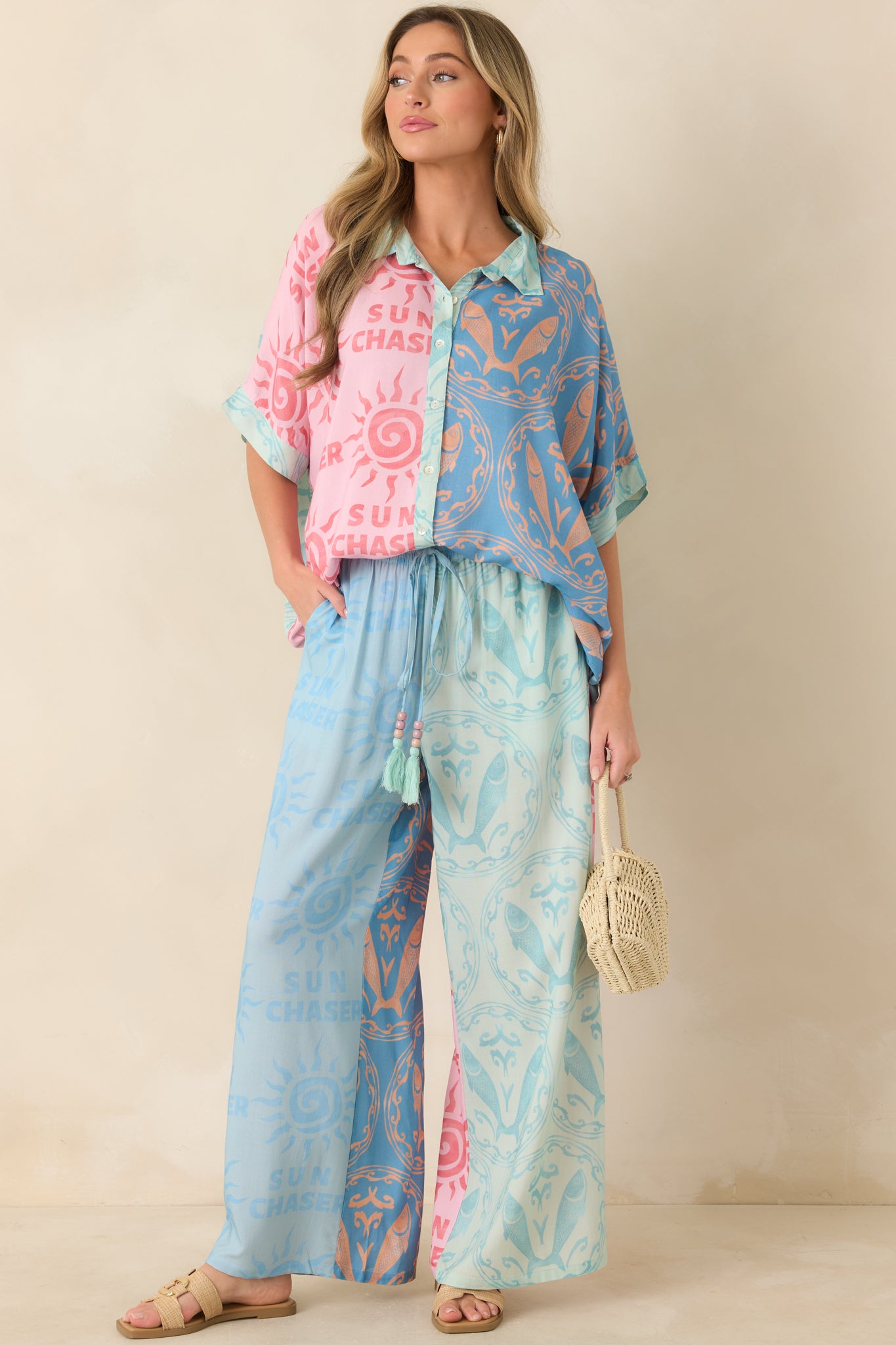 Multi colorblock button-up top featuring sun motifs, sea-inspired patterns, short sleeves, and a classic collar design.
