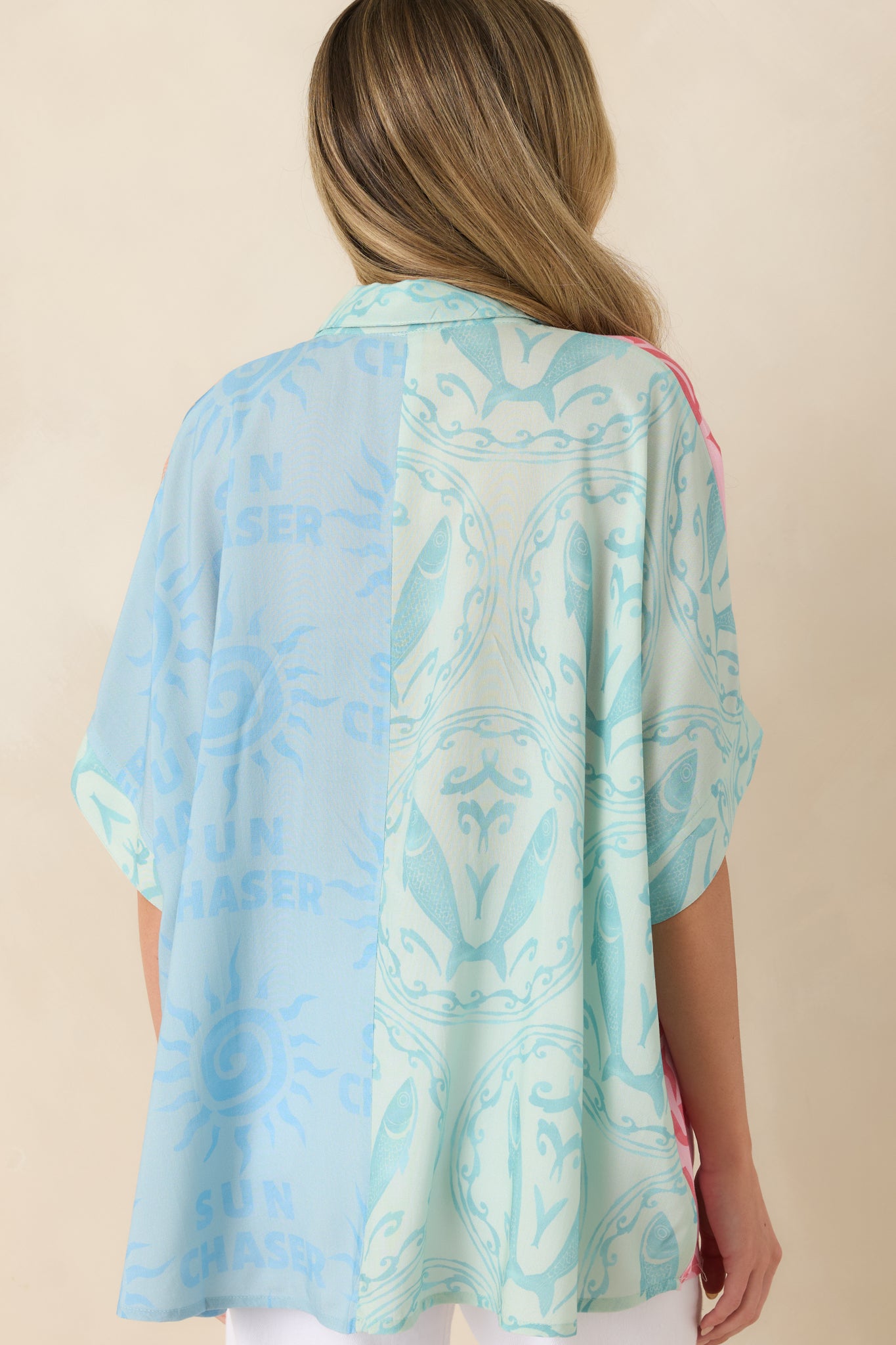 Back view of the multi colorblock top showcasing the relaxed fit, short sleeves, and printed design.