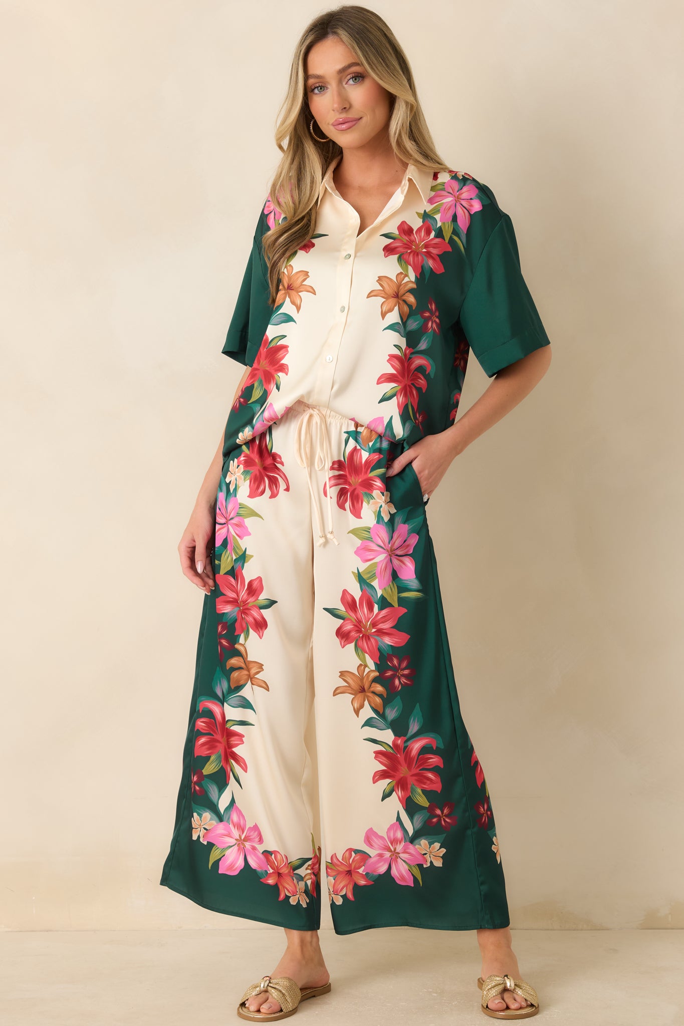 Lightweight teal multi floral pants showcasing a silky fabric finish, high-rise elastic waistband, and flowing wide-leg design.