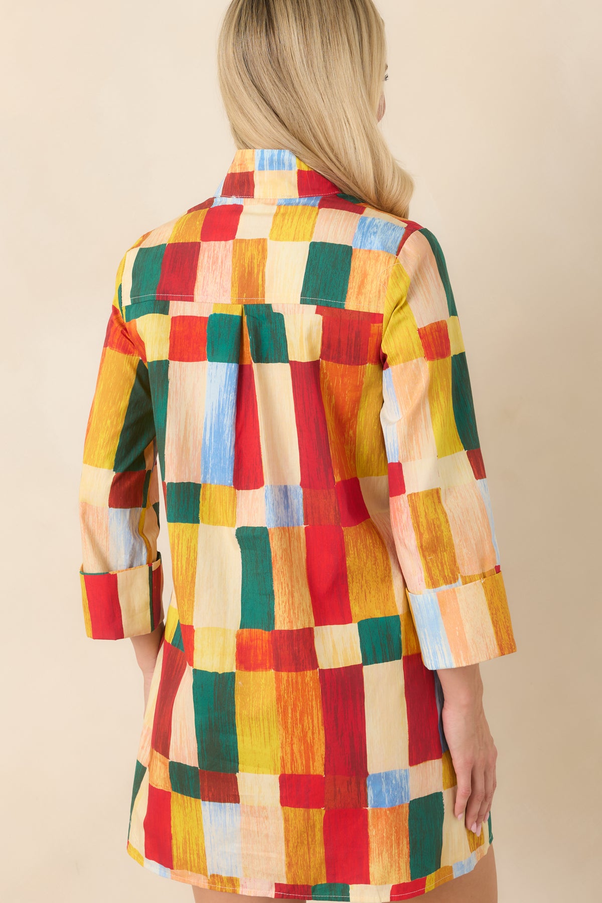Back view of multicolor abstract print mini dress featuring a standing collar, back yoke with center pleat, and relaxed silhouette.