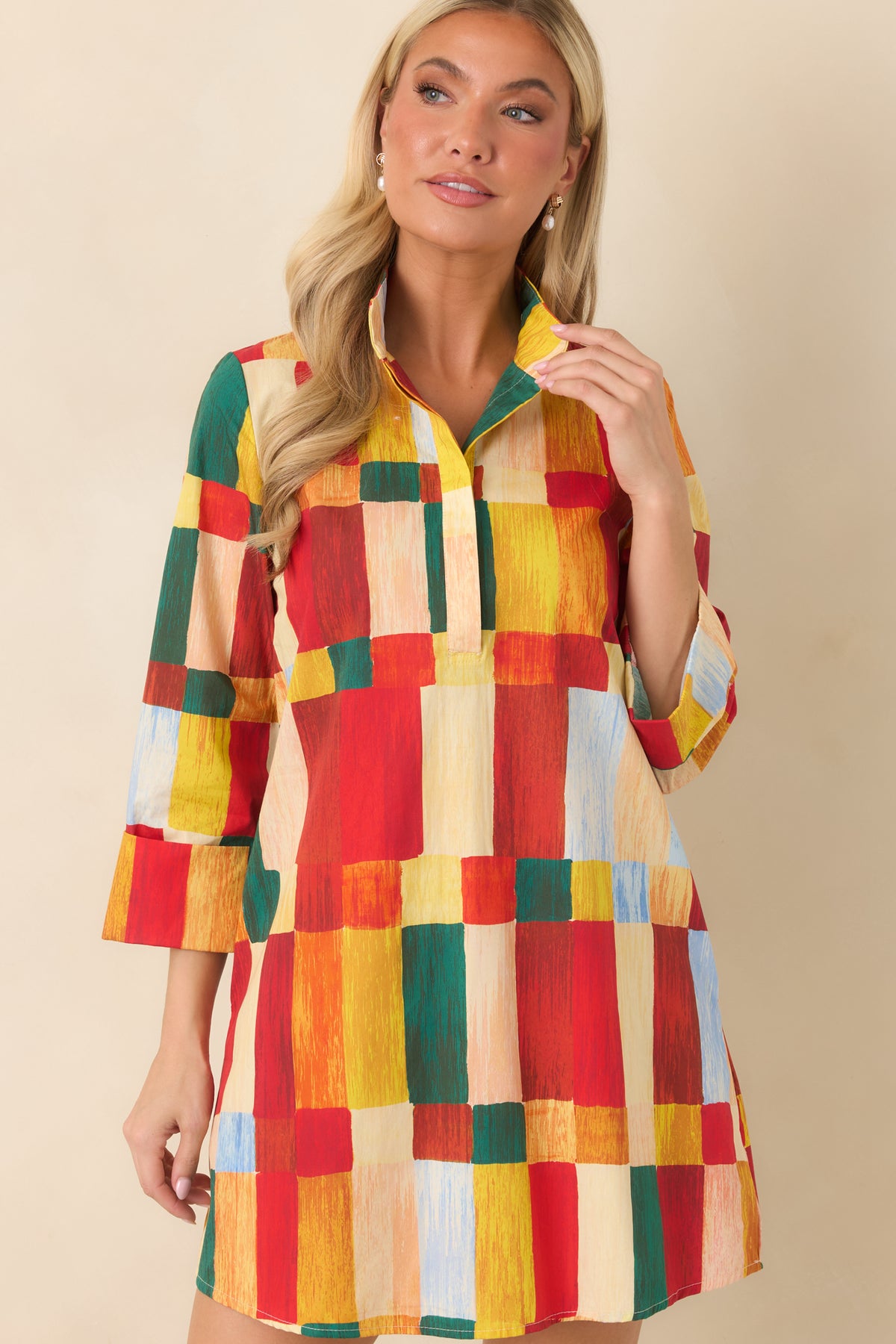 Multicolor abstract print mini dress featuring a standing collar, concealed partial button placket, and colorful brushstroke blocks.