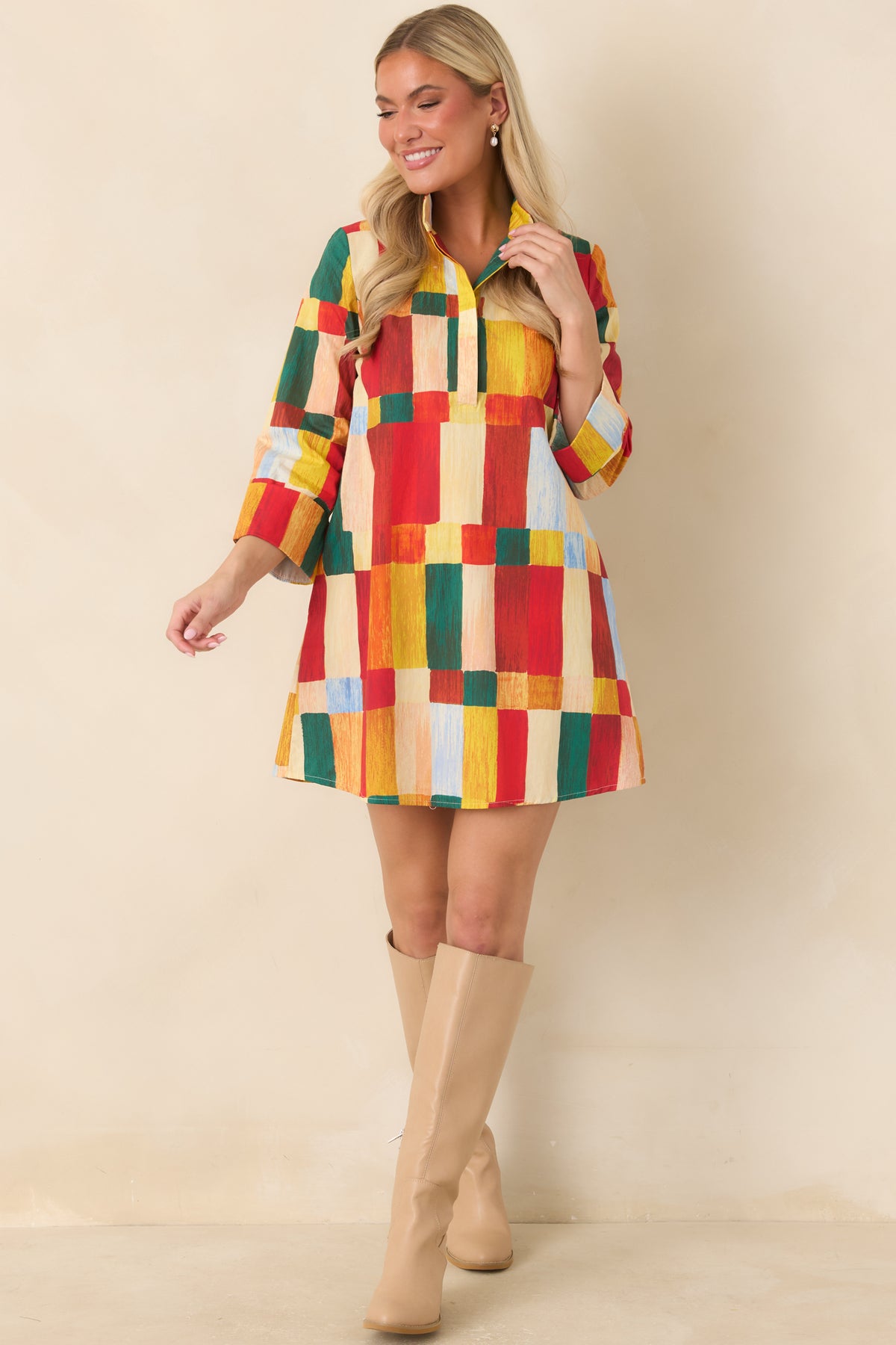 Multicolor abstract print mini dress featuring a slightly flared hemline, three-quarter sleeves, and a colorful geometric pattern.